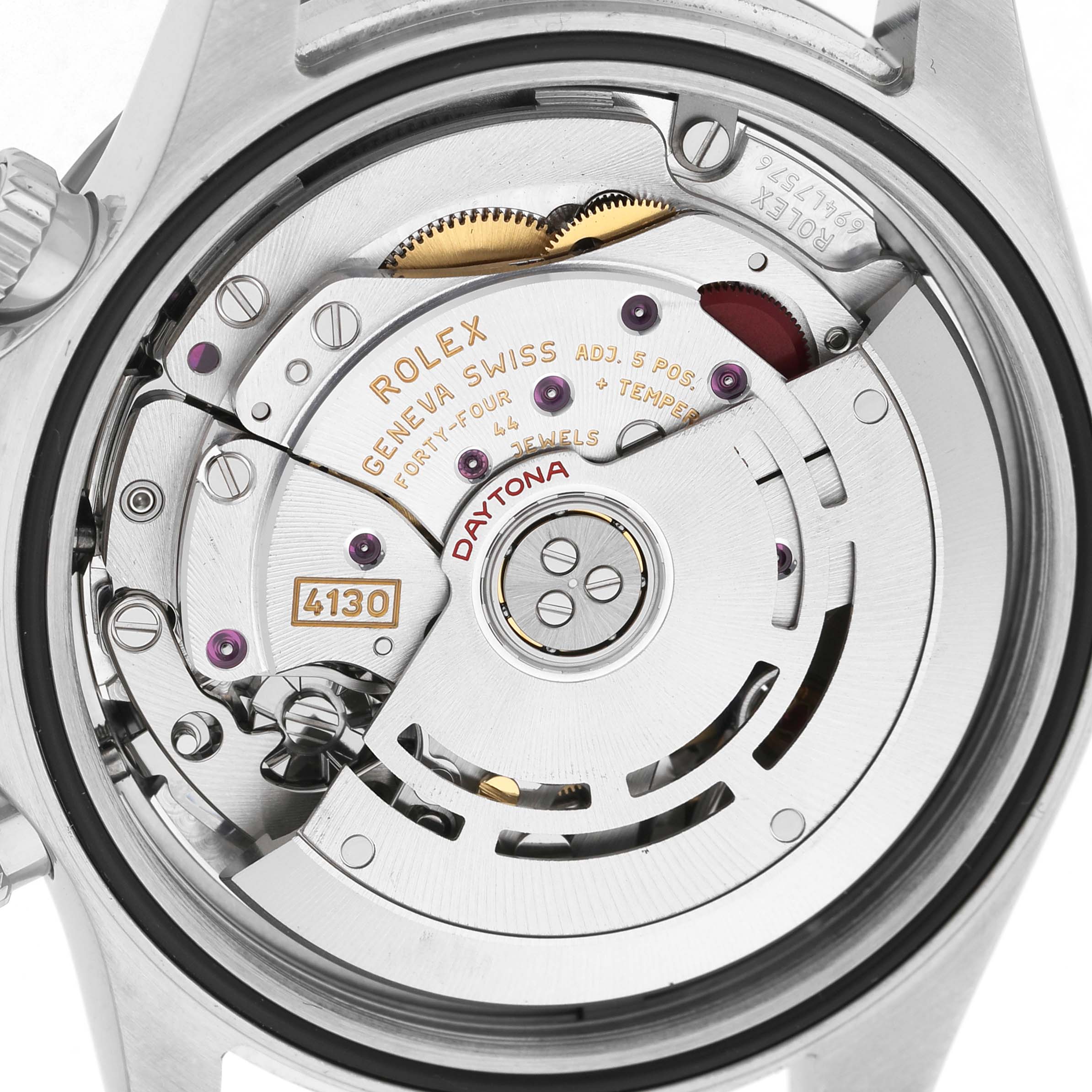 The image shows the back view of a Rolex Daytona 116500LN Men's Stainless Steel White Dial, highlighting its movement and mechanisms.