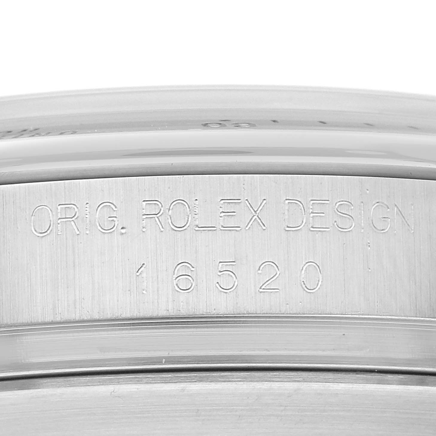 The image shows an up-close view of the case side of the Rolex Daytona 16520 Men's Stainless Steel White Dial 16520 Men's Stainless Steel White Dial watch, displaying the engraving "ORIG. ROLEX DESIGN 16520."