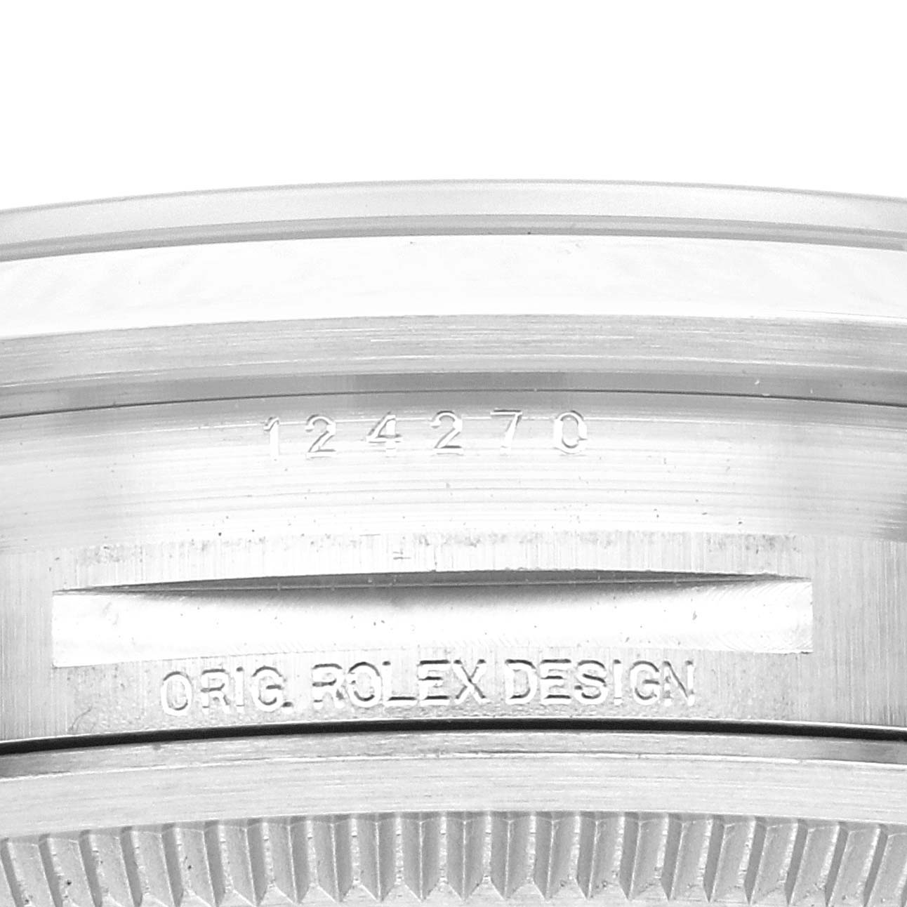 This image shows a close-up of the side case of the Rolex Explorer 124270 Men
s Stainless Steel Black Dial 124270 Men
s Stainless Steel Black Dial watch, featuring its model number and "ORIG. ROLEX DESIGN" engraving.