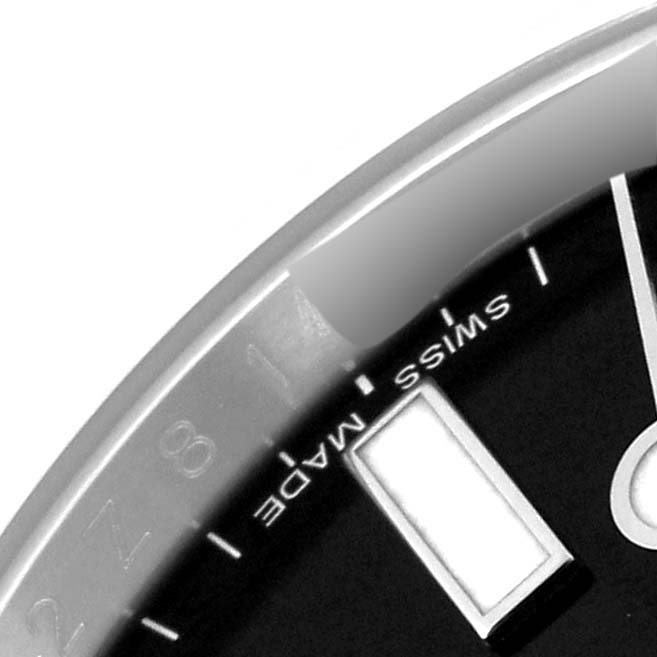 The image shows a close-up of the dial and bezel of the Rolex Explorer 216570 Men
s Stainless Steel Black Dial 216570 Men
s Stainless Steel Black Dial watch with "SWISS MADE" visible.