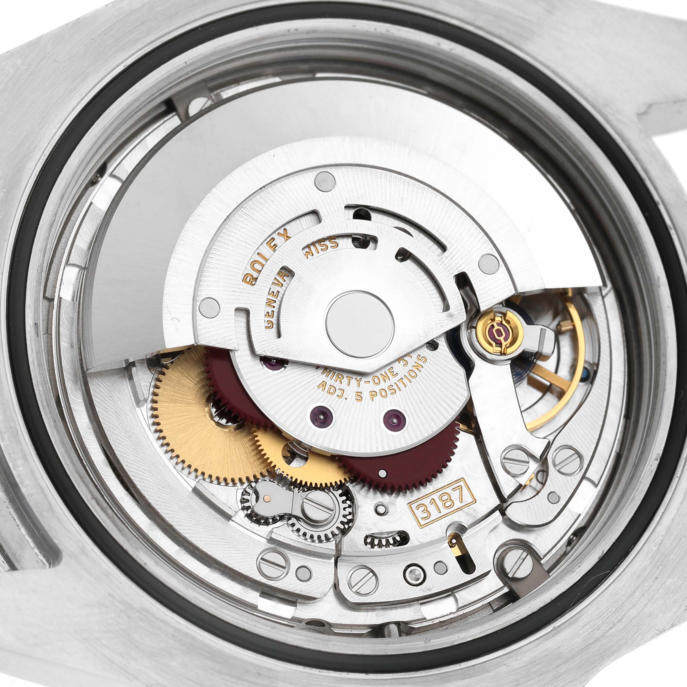 The image shows a close-up of the Rolex Explorer 216570 Men's Stainless Steel White Dial's movement, showcasing gears and components from the back.