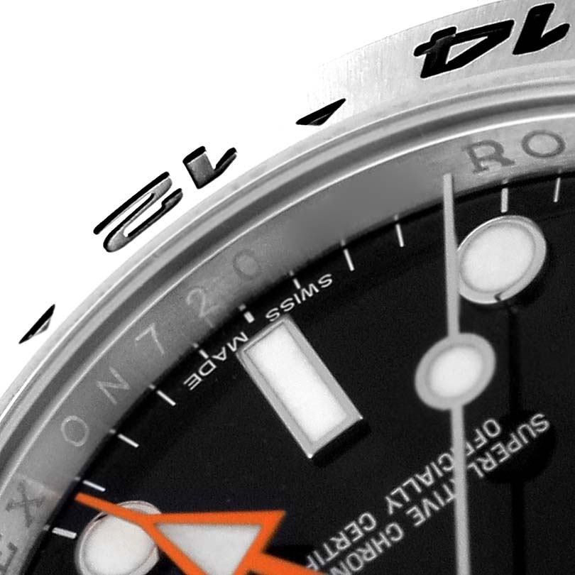 This close-up image shows the bezel, partial dial, and orange GMT hand of a Rolex Explorer 216570 Men's Stainless Steel Black Dial 216570 Men's Stainless Steel Black Dial model.