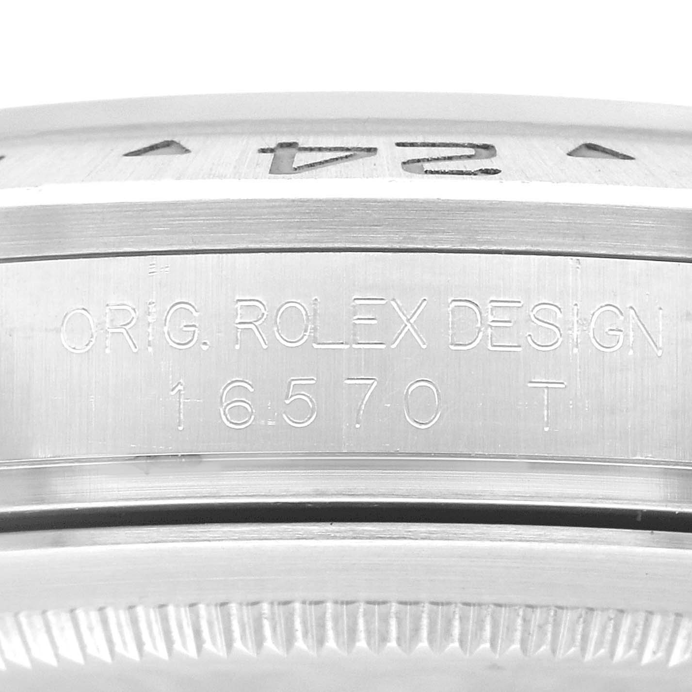 The image shows a close-up of the side of the Rolex Explorer 16570 Men's Stainless Steel White Dial 16570 Men's Stainless Steel White Dial model with the engraving "ORIG. ROLEX DESIGN 16570 T".