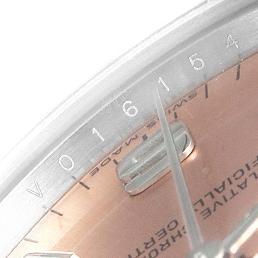 The image shows a close-up angle of the dial, bezel, and hands of a Mid-Size Rolex watch.