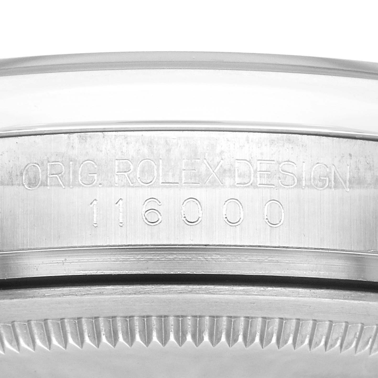 The image shows a close-up of the side profile of a Rolex Oyster Perpetual 116000 Men
s Stainless Steel Silver Dial 116000 Men
s Stainless Steel Silver Dial, focusing on the engraved model number and design details.