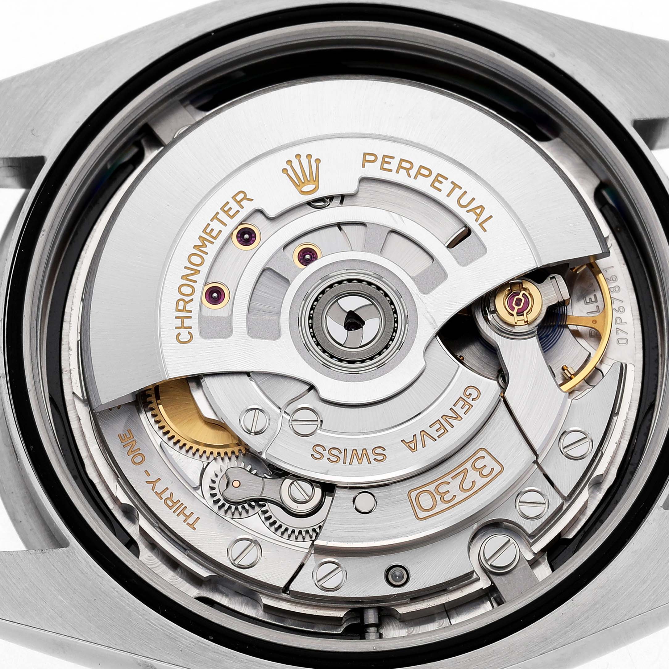 The image shows the movement and components of a Rolex Oyster Perpetual 124300 Men's Stainless Steel Black Dial watch viewed from the back.