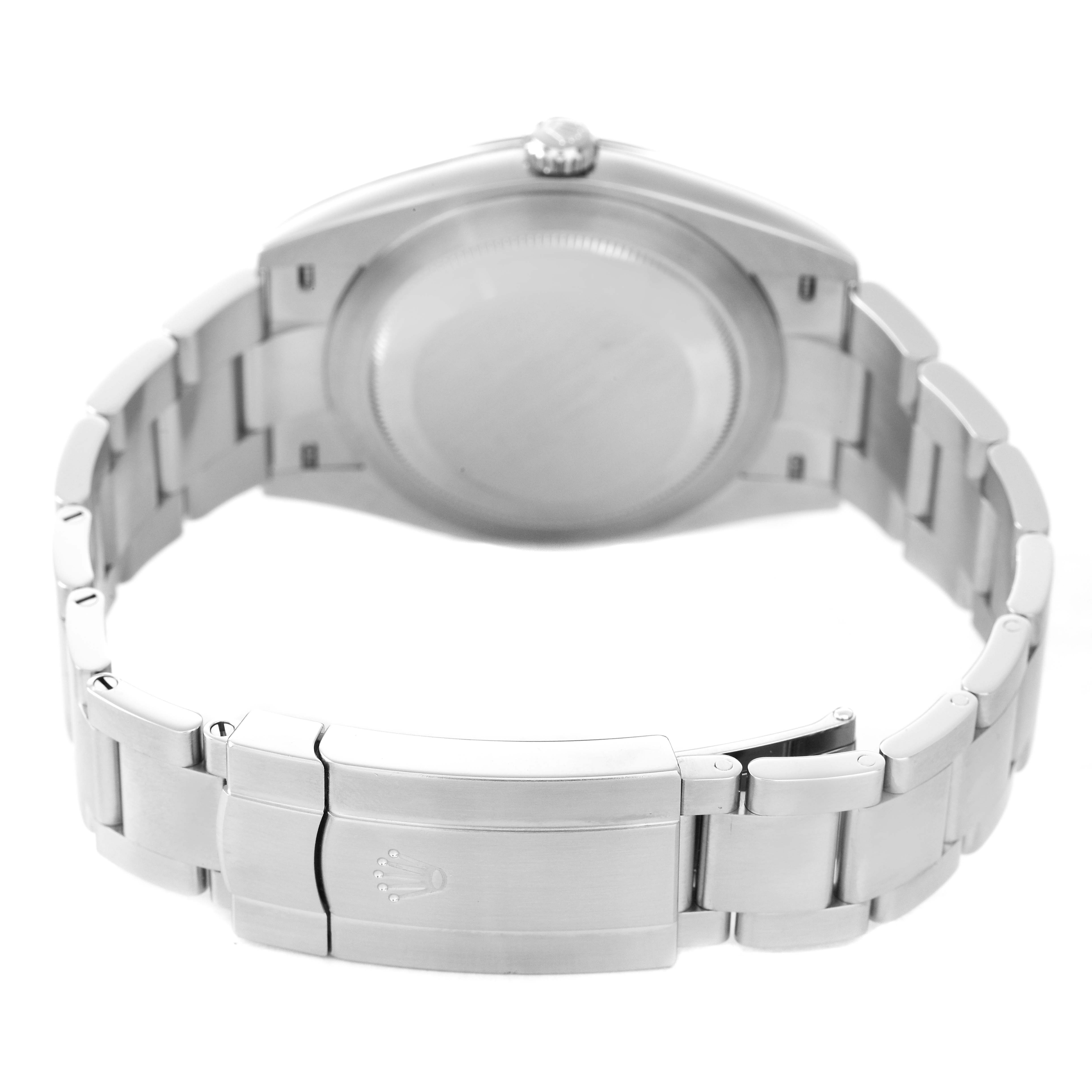 The image shows the back of a Rolex Oyster Perpetual 124300 Men's Stainless Steel Black Dial watch, highlighting the case back and bracelet clasp.
