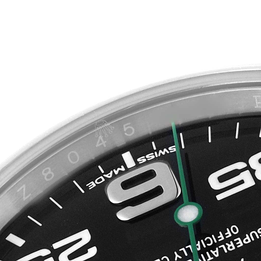 This is a close-up of the top part of the dial and case of a Rolex Air-King 116900 Men's Stainless Steel Black Dial 116900 Men's Stainless Steel Black Dial watch.