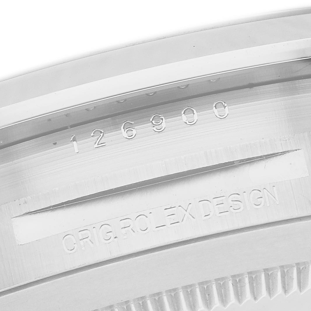 The image shows a close-up of the Rolex Air-King 126900 Men's Stainless Steel Black Dial 126900 Men's Stainless Steel Black Dial's case side, displaying its engraved model number.