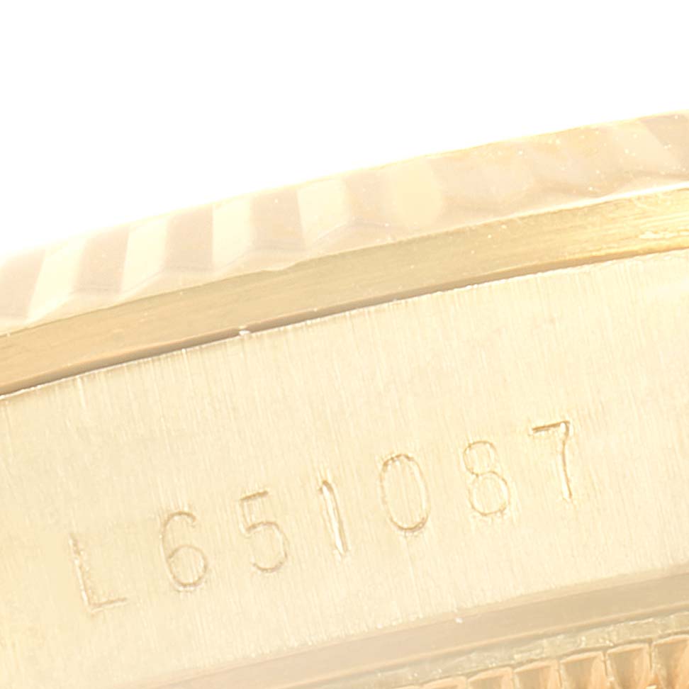 This close-up image shows the side of a Rolex President 68278 Women
s Yellow Gold Champagne Dial 68278 Women
s Yellow Gold Champagne Dial model, highlighting its serial number and fluted bezel.