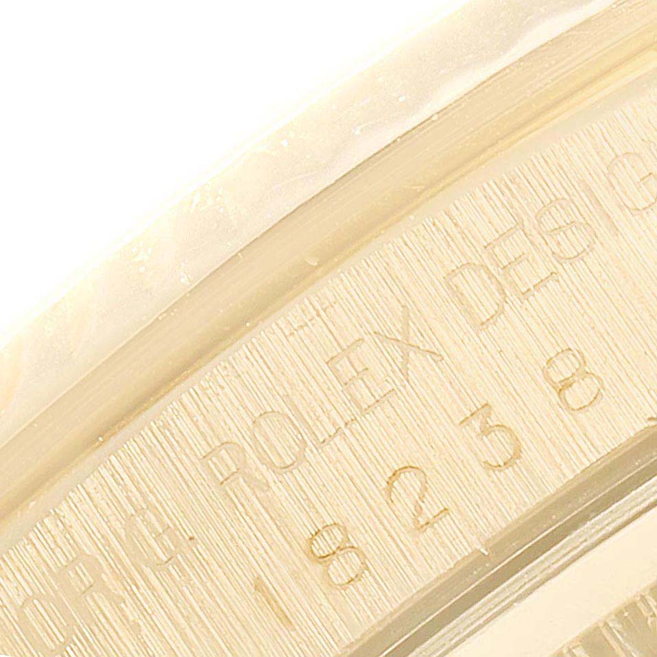 This image shows a close-up of the side of the Rolex President 18238 Men's Yellow Gold Black Dial 18238 Men's Yellow Gold Black Dial model watch, featuring engraved serial and reference numbers.