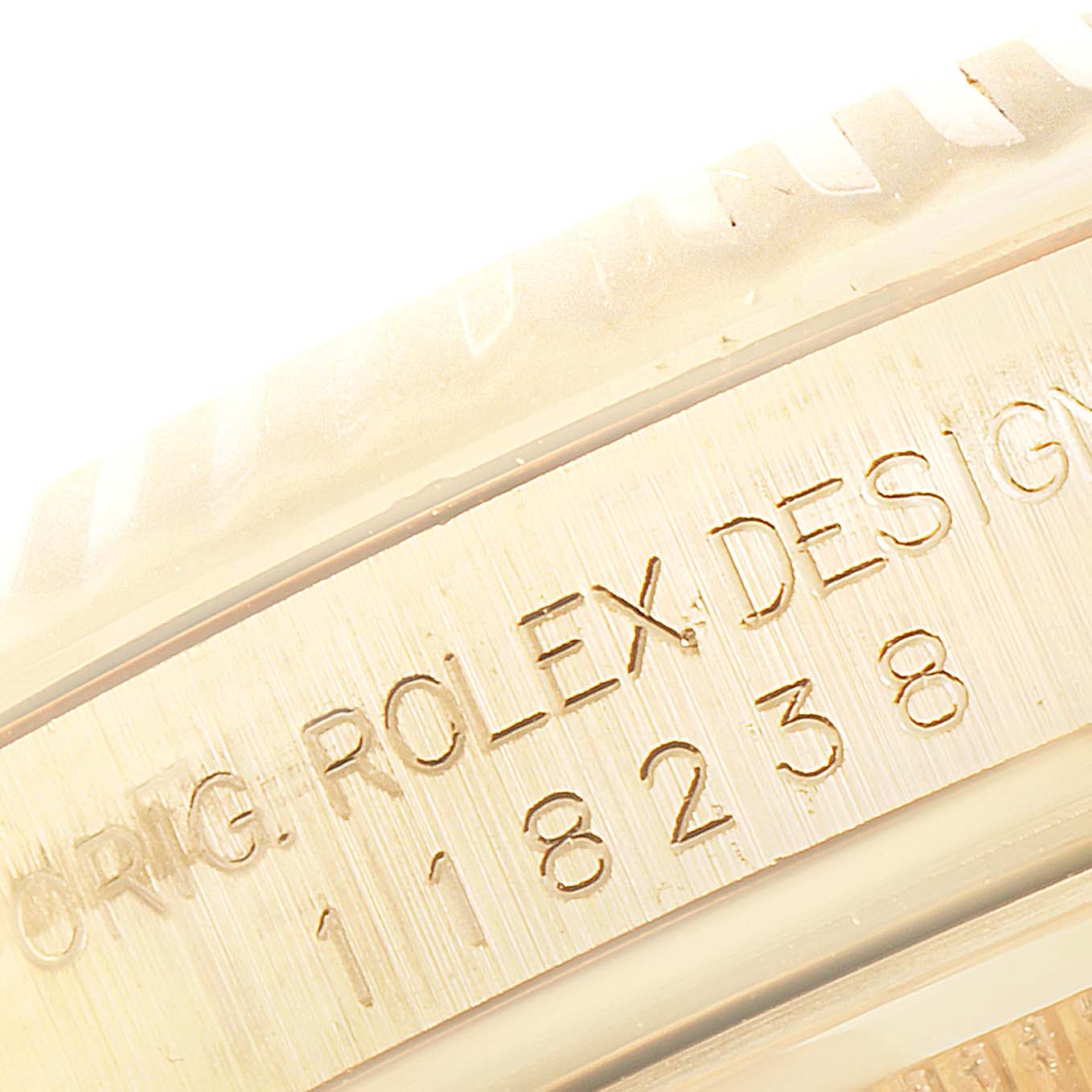 This close-up image shows the engraved case side of the Rolex President 118238 Men
s Yellow Gold Black Dial 118238 Men
s Yellow Gold Black Dial model watch.