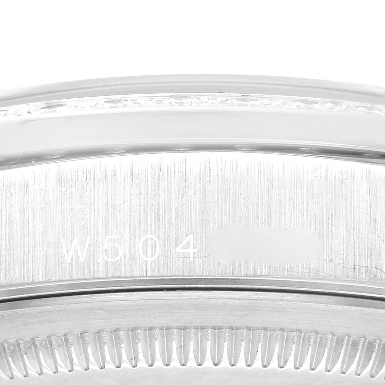 This is a close-up image of the engraved case back and fluted bezel of the Rolex President 18346 Men's Platinum Silver Dial 18346 Men's Platinum Silver Dial model watch.