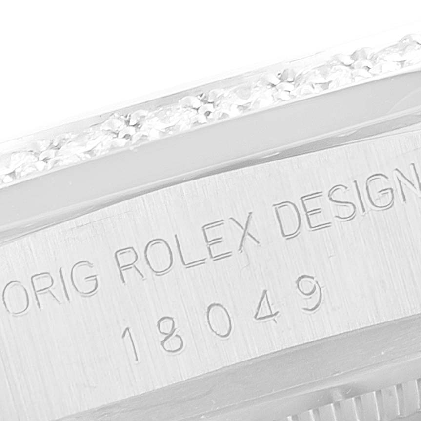 This close-up image shows a partial view of the case and bezel of a Rolex President 18049 Men
s White Gold Silver Dial 18049 Men
s White Gold Silver Dial model watch, displaying its engraved reference number.