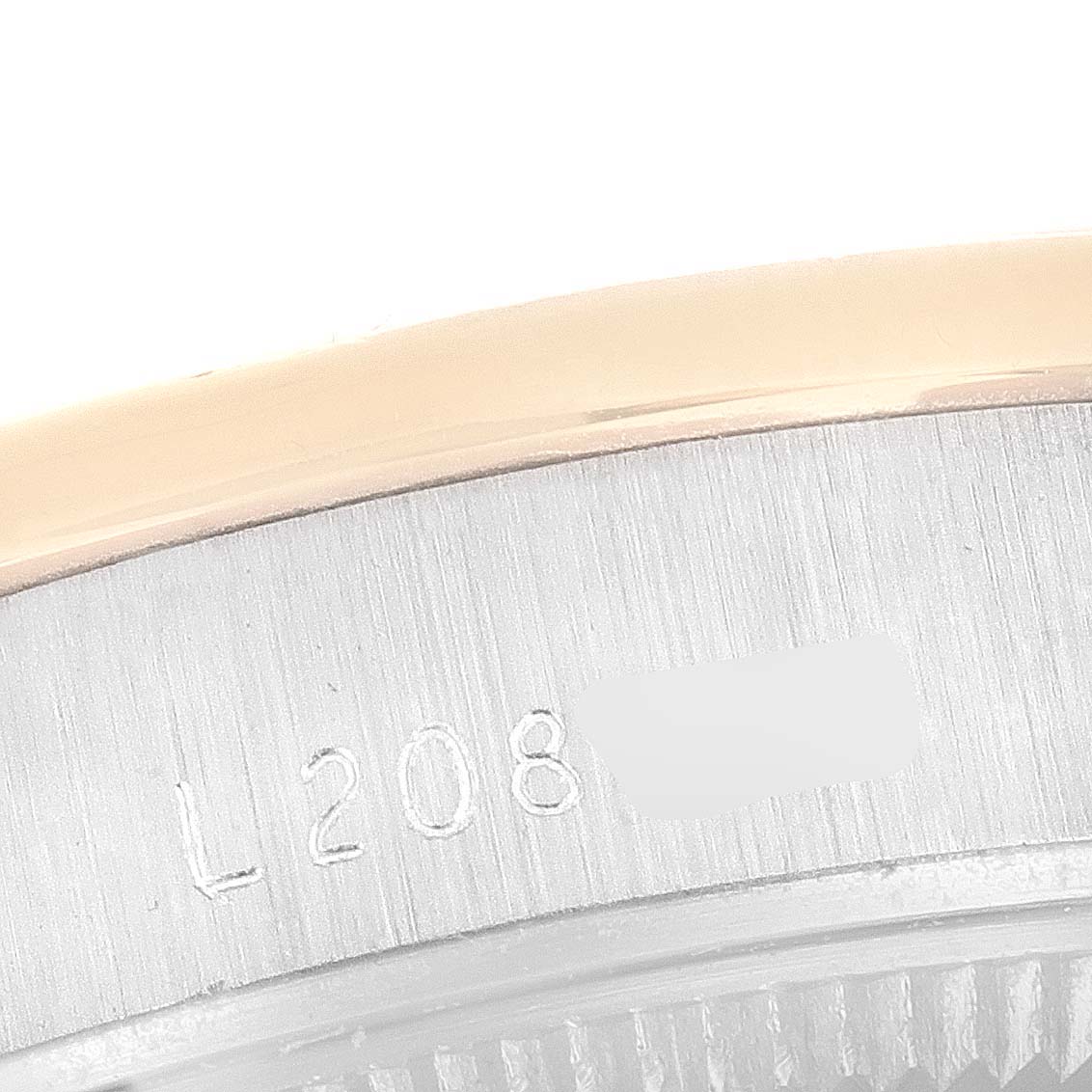 The image shows a close-up of the side of the Rolex President 68149 Women's White Gold Brown Dial 68149 Women's White Gold Brown Dial model watch, featuring part of the bezel and engraved serial number.