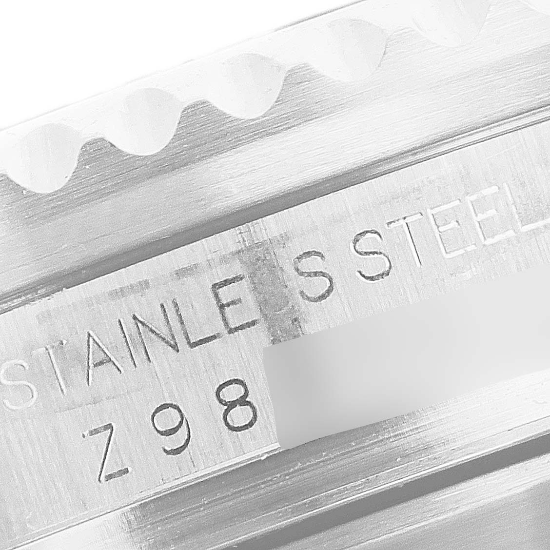 This close-up image of the Rolex Sea-Dweller 16600 Men
s Stainless Steel Black Dial 16600 Men
s Stainless Steel Black Dial watch shows the stainless steel casing, including part of the bezel and engraved serial number.