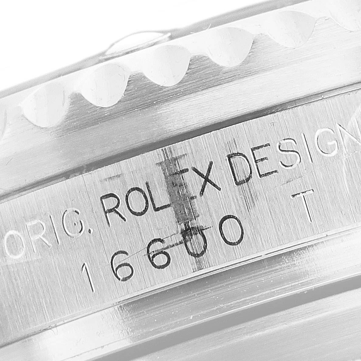 The image shows a close-up of the bezel and case of a Rolex Sea-Dweller 16600 Men
s Stainless Steel Black Dial 16600 Men
s Stainless Steel Black Dial model, displaying the engraved text.