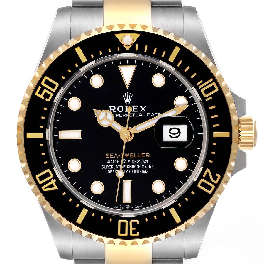 The Rolex Sea-Dweller is shown from the front, highlighting the dial, bezel, crown, and part of the bracelet.