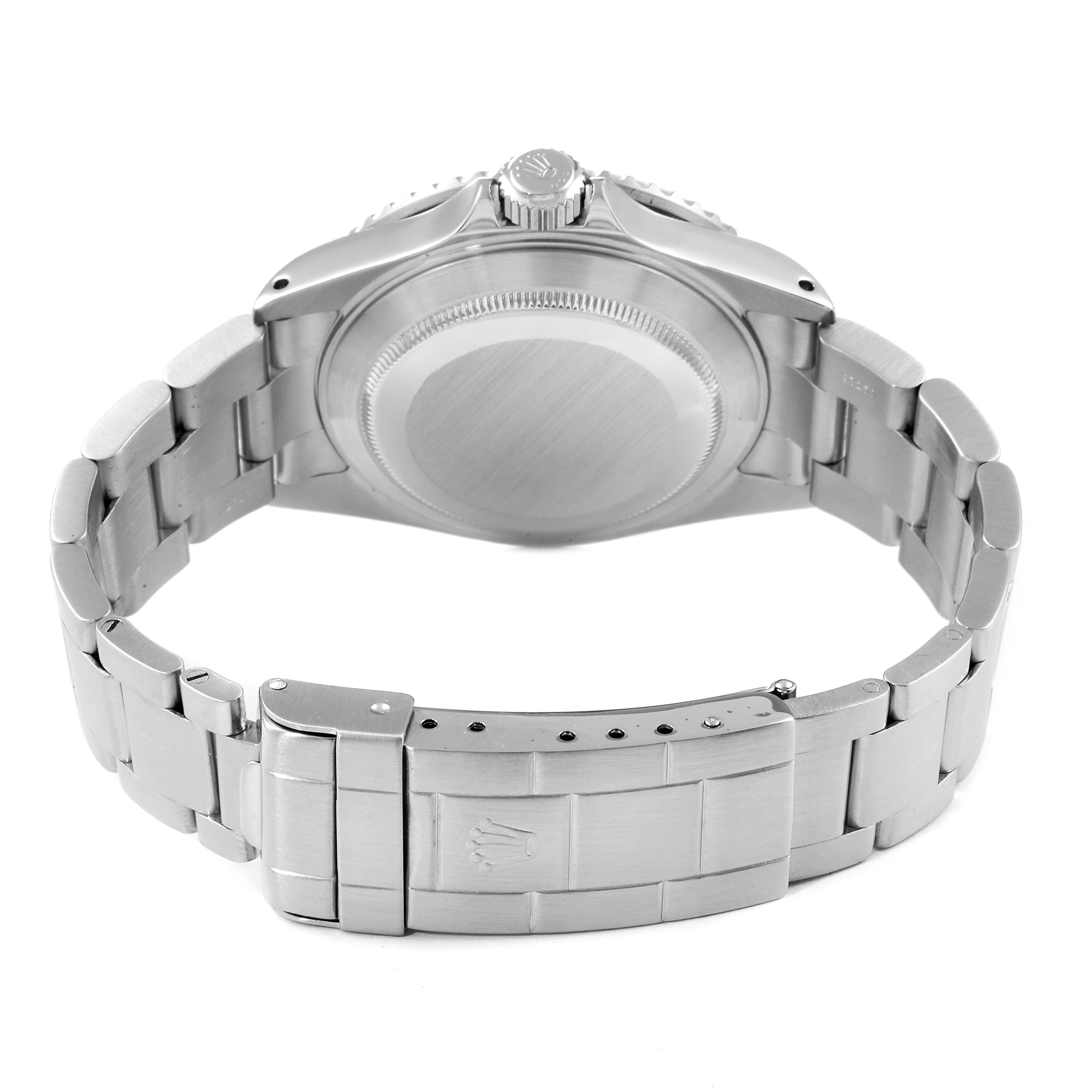 The image shows the back view of a Rolex Submariner 16610 Men
s Stainless Steel Black Dial 16610 Men
s Stainless Steel Black Dial, displaying its case back, crown, and metal bracelet clasp.