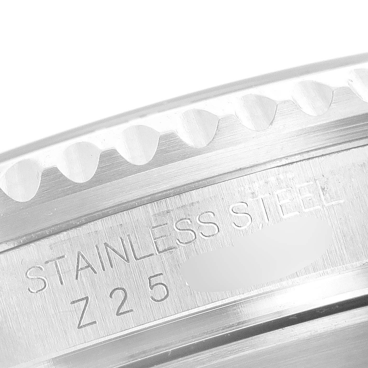 This close-up image shows part of the stainless steel caseback and bezel of a Rolex Submariner 16610 Men
s Stainless Steel Black Dial 16610 Men
s Stainless Steel Black Dial watch.