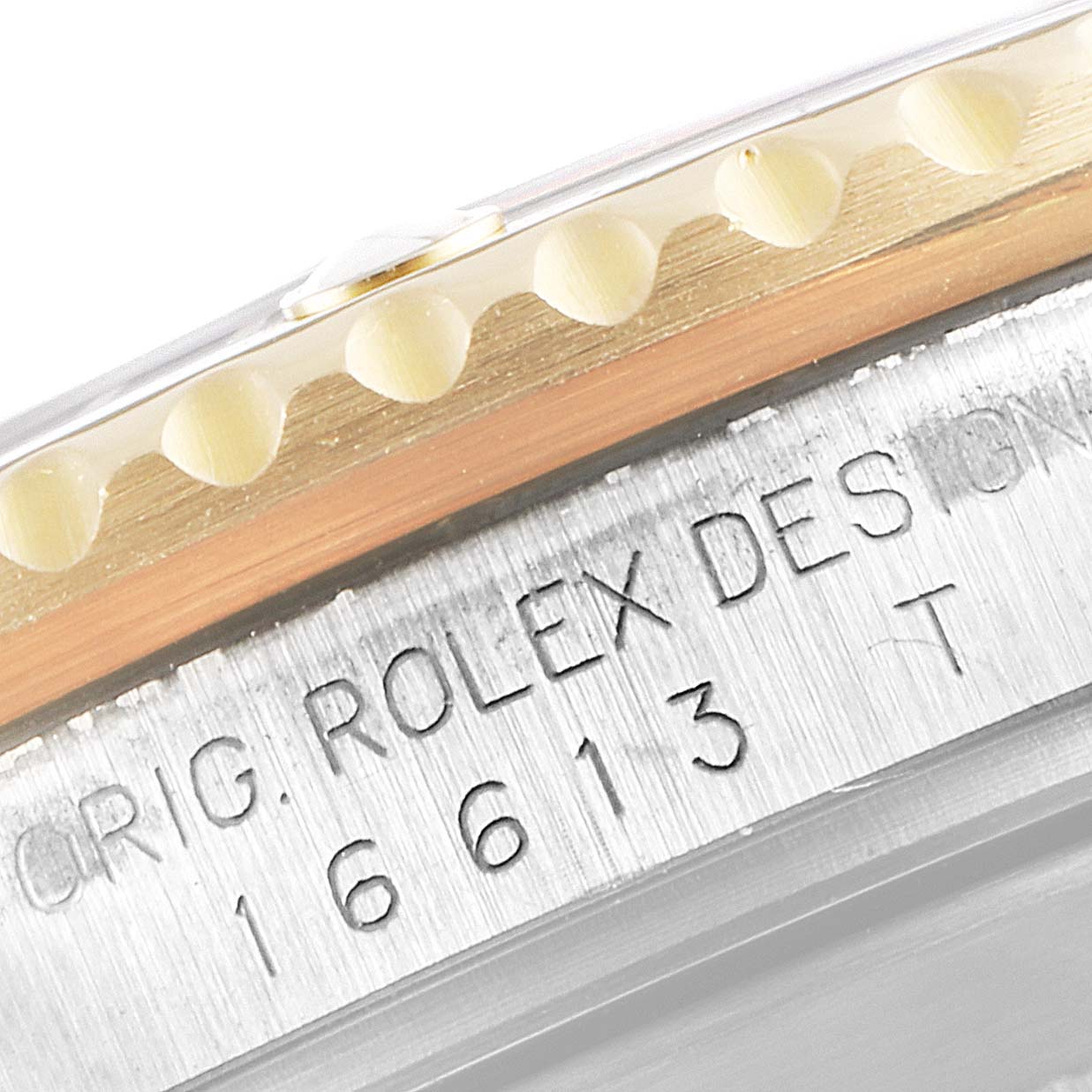 This close-up image shows the engraved bezel and case side of a Rolex Submariner 16613 Men
s Steel and Gold (two tone) Blue Dial 16613 Men
s Steel and Gold (two tone) Blue Dial model, displaying part of its serial number and branding.