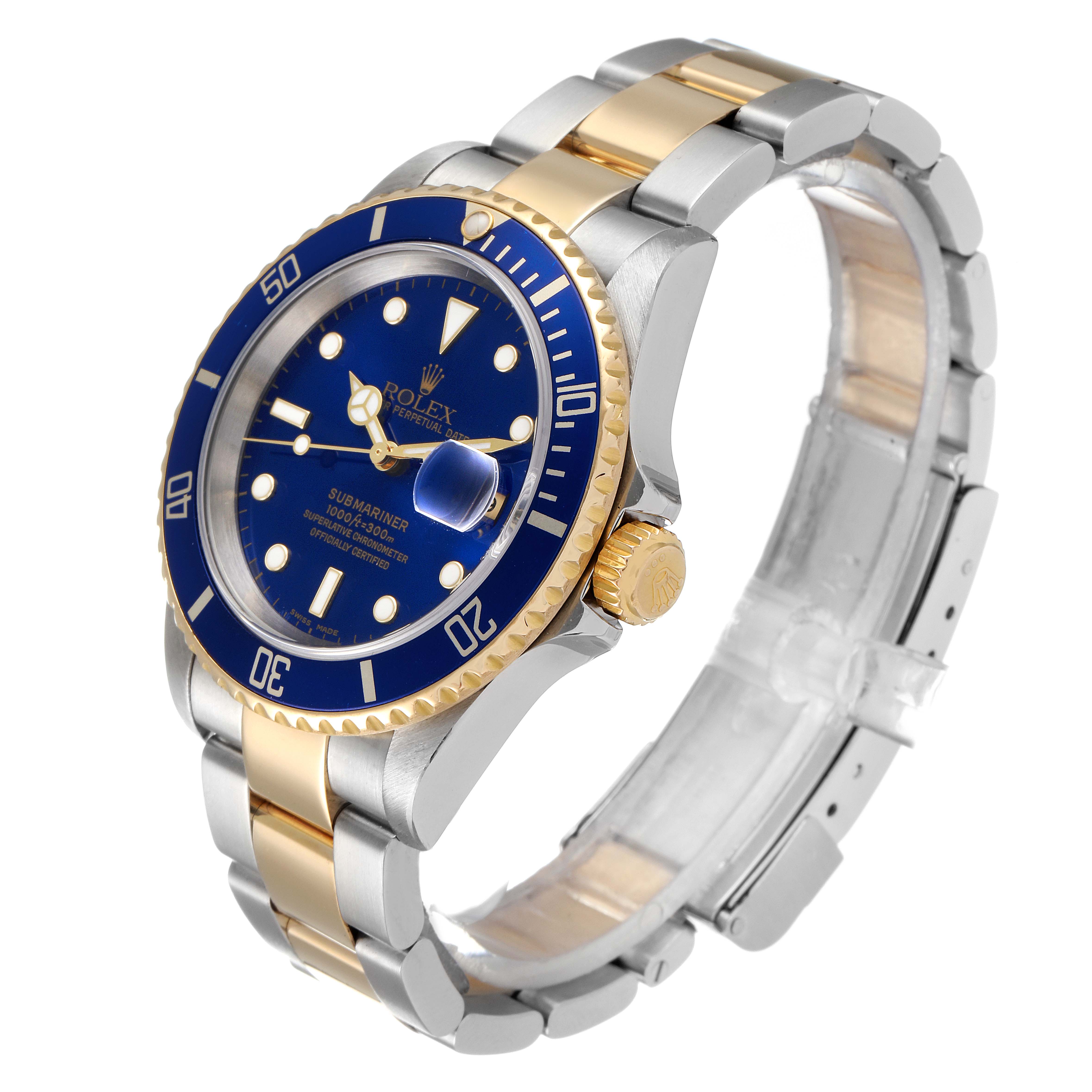 The Rolex Submariner 16613 Men
s Steel and Gold (two tone) Blue Dial 16613 Men
s Steel and Gold (two tone) Blue Dial watch is shown at a three-quarter angle, displaying the blue dial, bezel, gold crown, and two-tone bracelet.
