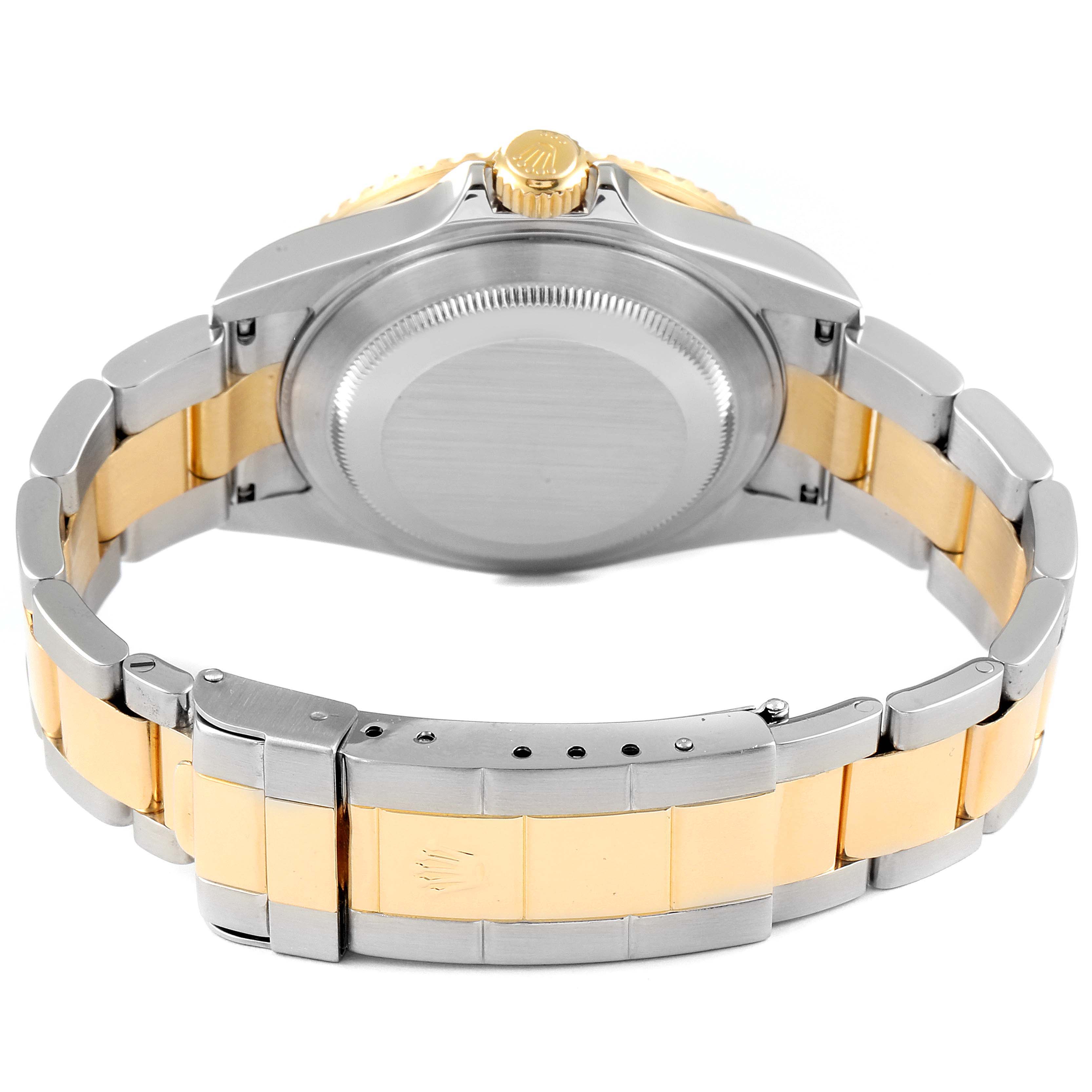 The image shows the back case and bracelet of a Rolex Submariner 16613 Men
s Steel and Gold (two tone) Blue Dial 16613 Men
s Steel and Gold (two tone) Blue Dial watch in a two-tone metal design.