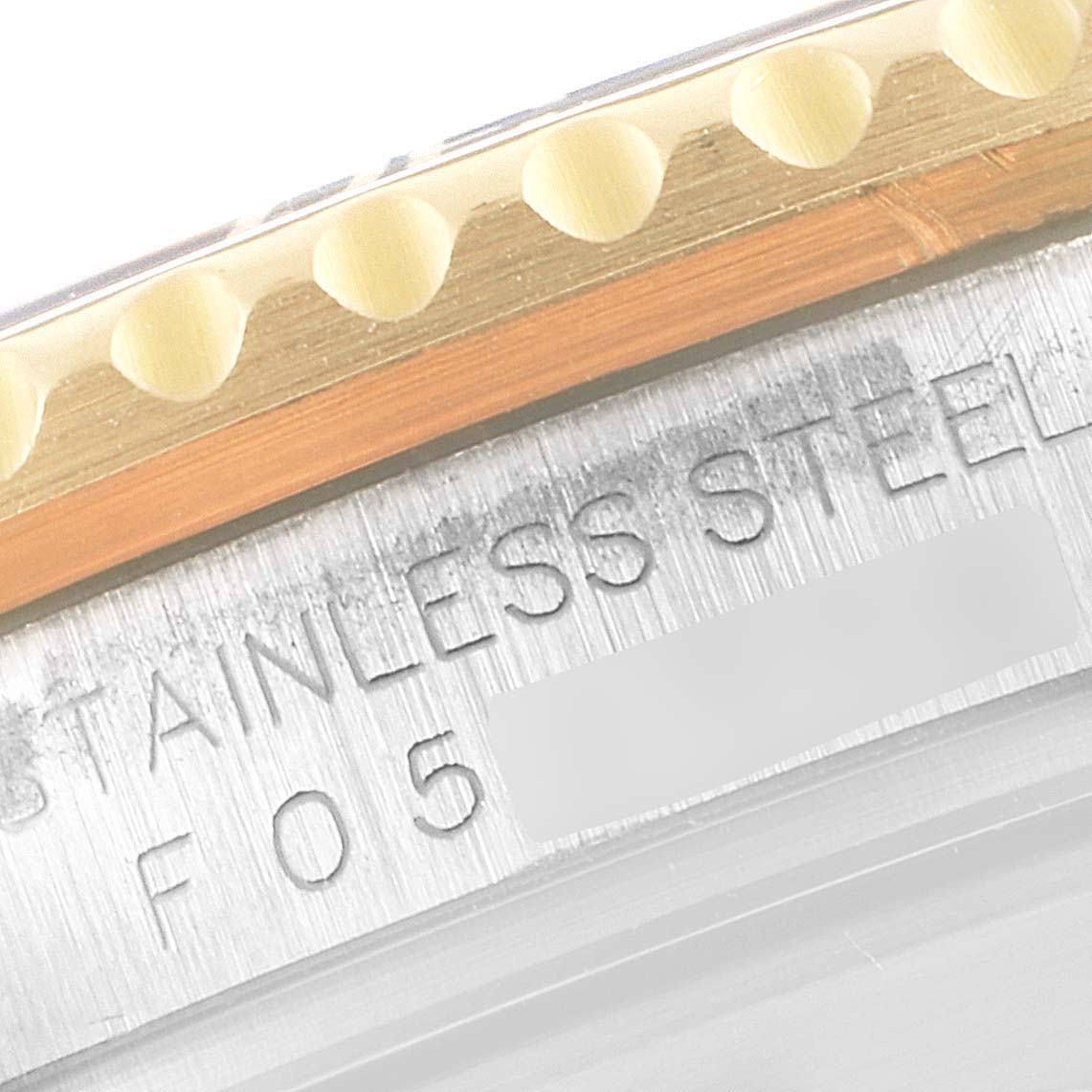 The image shows a close-up of the bezel edge and part of the stainless steel case of a Rolex Submariner 16613 Men
s Steel and Gold (two tone) Blue Dial 16613 Men
s Steel and Gold (two tone) Blue Dial watch.