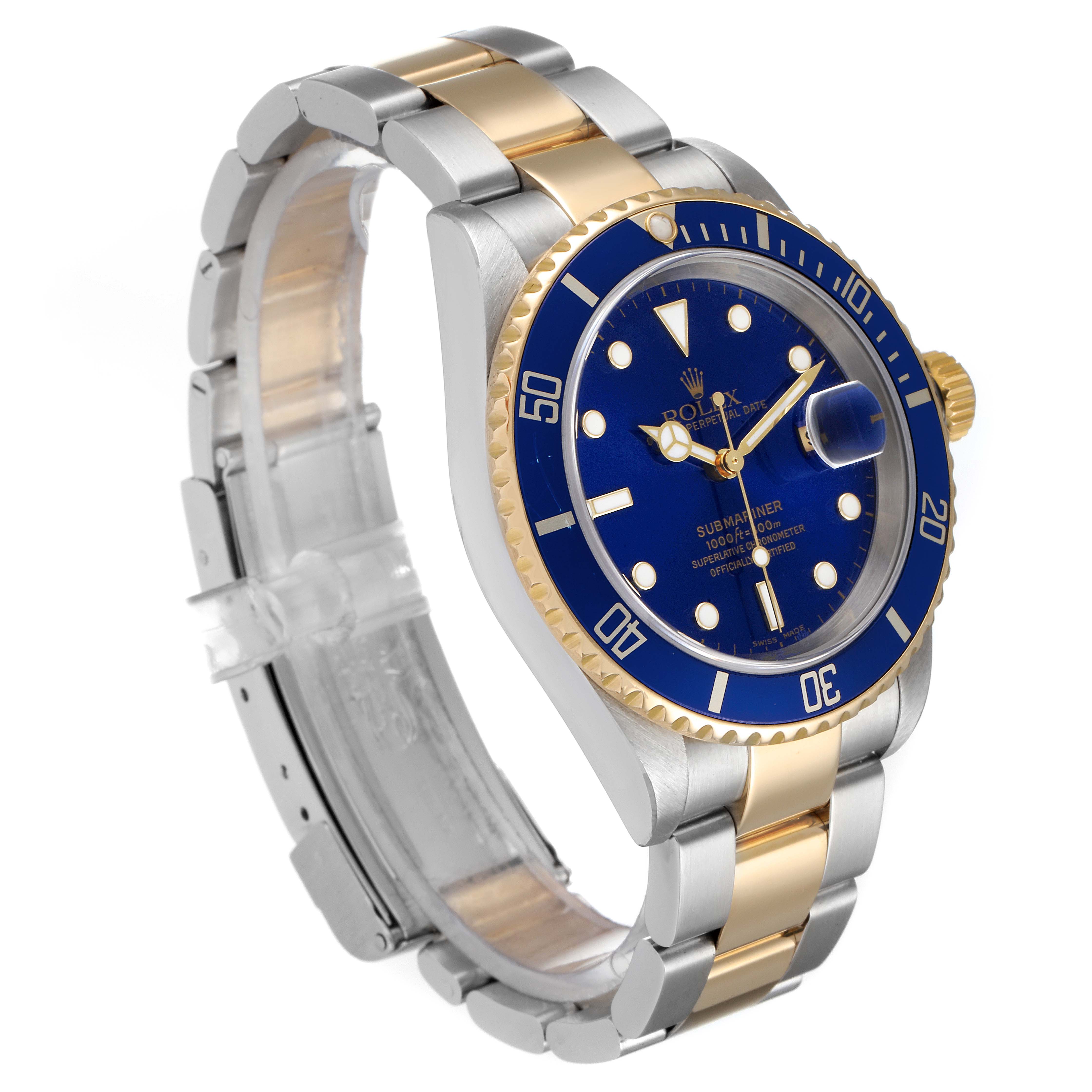 The Rolex Submariner 16613 Men
s Steel and Gold (two tone) Blue Dial 16613 Men
s Steel and Gold (two tone) Blue Dial watch is shown at a three-quarter angle, showcasing the blue dial, gold bezel, and two-tone bracelet.