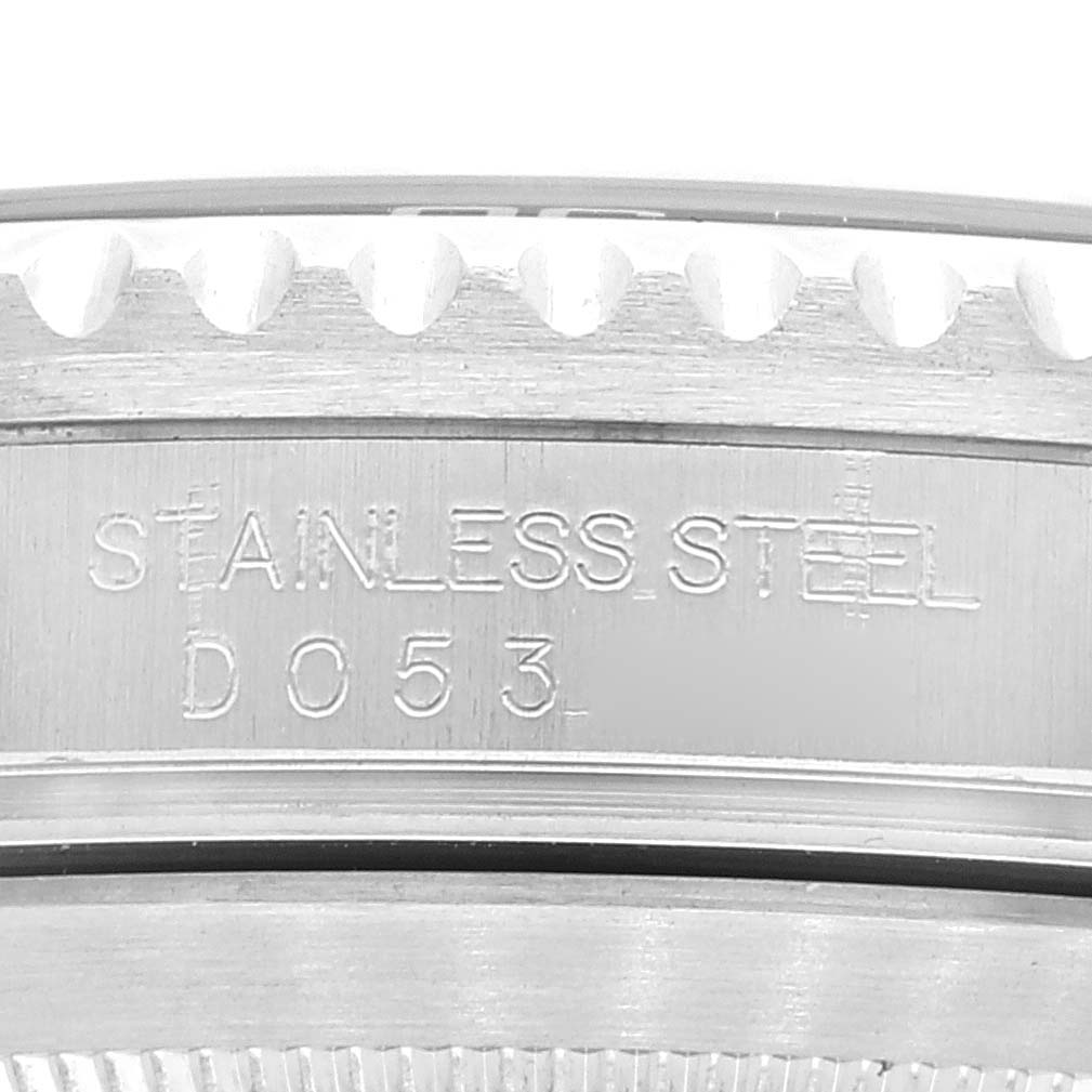 This close-up image of the Rolex Submariner 16610 Men
s Stainless Steel Black Dial 16610 Men
s Stainless Steel Black Dial shows the engraved text "STAINLESS STEEL D 0 5 3" on its side.