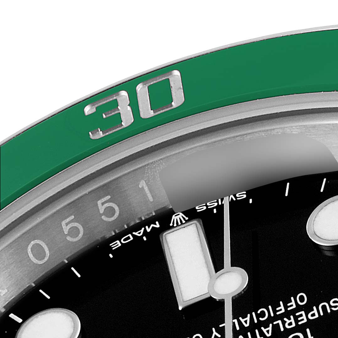 This close-up image shows the green and silver bezel, 30-minute marker, and part of the dial and hands of a Rolex Submariner 126610LV Men's Stainless Steel Black Dial 126610LV Men's Stainless Steel Black Dial watch.