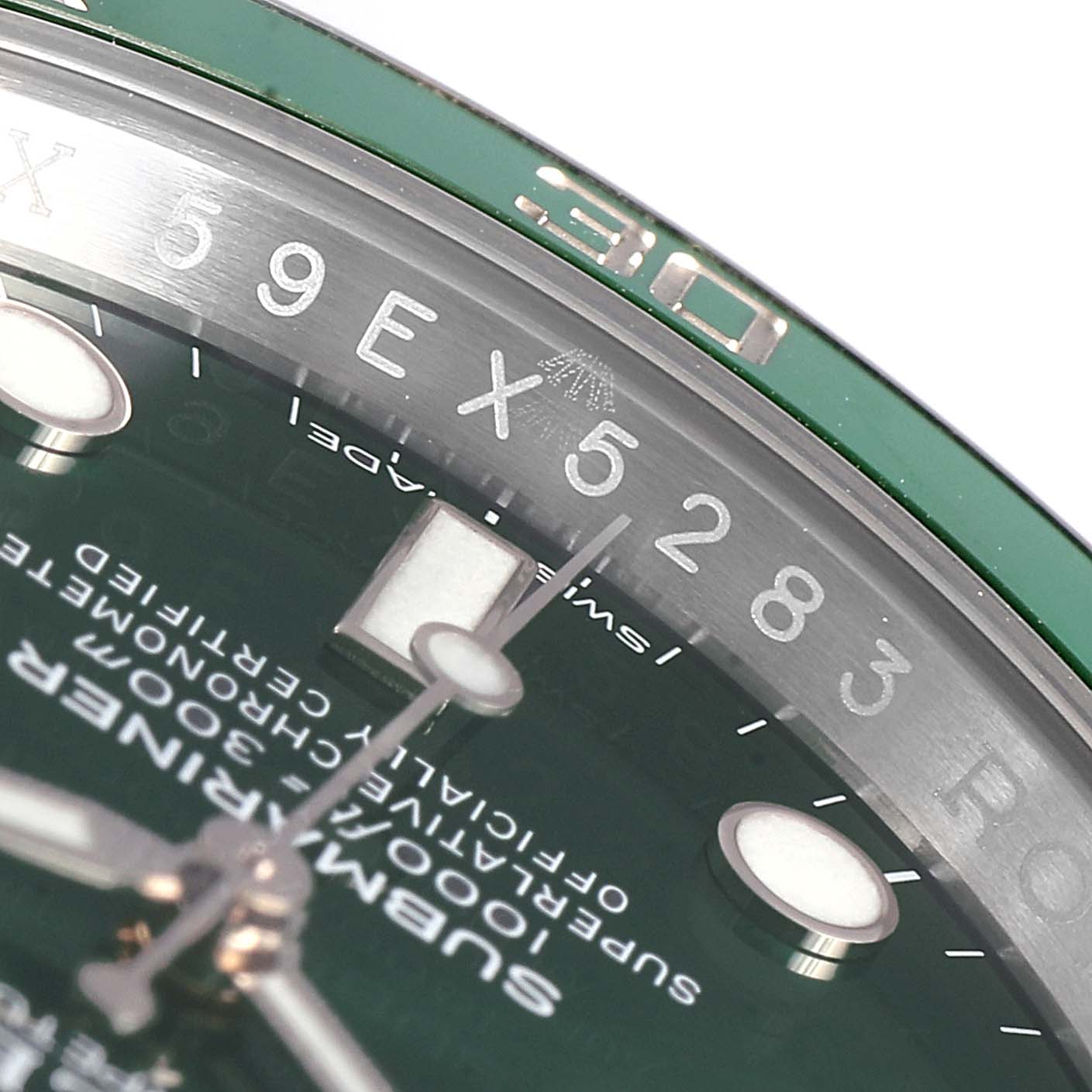 This close-up image of a Rolex Submariner 116610LV Men
s Stainless Steel Green Dial 116610LV Men
s Stainless Steel Green Dial watch shows the upper section of the dial, bezel, and part of the minute and second hands.