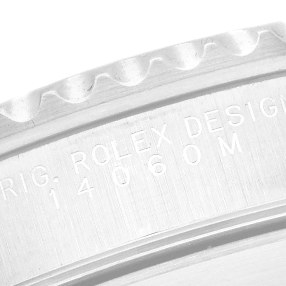 The image shows a close-up of the engraved side of a Rolex Submariner 14060 Men
s Stainless Steel Black Dial 14060 Men
s Stainless Steel Black Dial watch, focusing on the bezel and case edge.