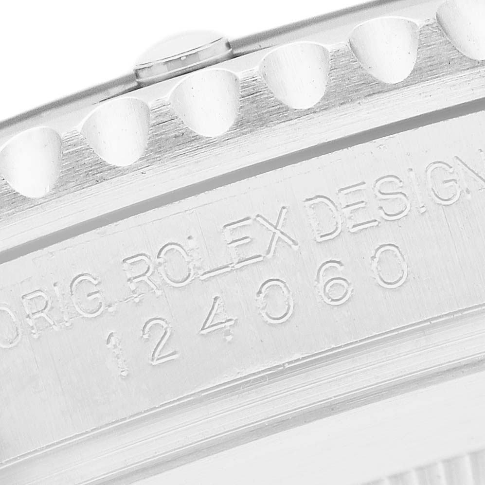 The image shows a close-up of the engraved side of a Rolex Submariner 124060 Men's Stainless Steel Black Dial, highlighting the model number and design details.