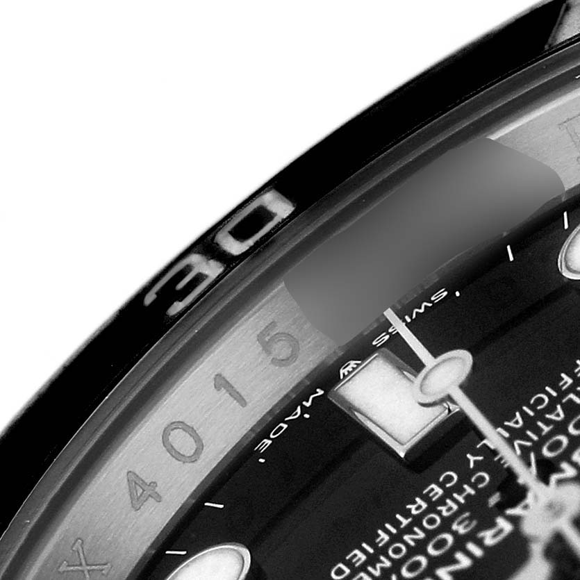 The image shows a close-up of the bezel and dial edge of a Rolex Submariner 124060 Men's Stainless Steel Black Dial watch, focusing on the markings.