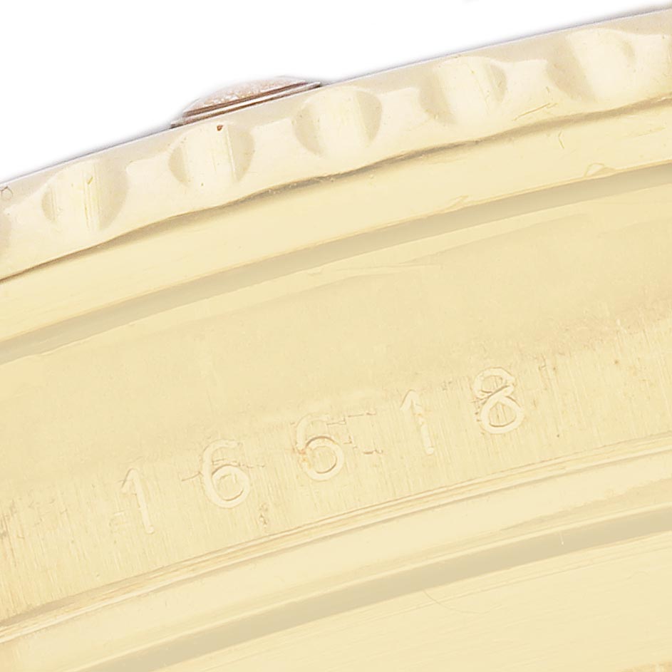 The image shows a close-up of the bezel and part of the case with engravings for the Rolex Submariner 16618 Men's Yellow Gold Champagne Dial 16618 Men's Yellow Gold Champagne Dial.