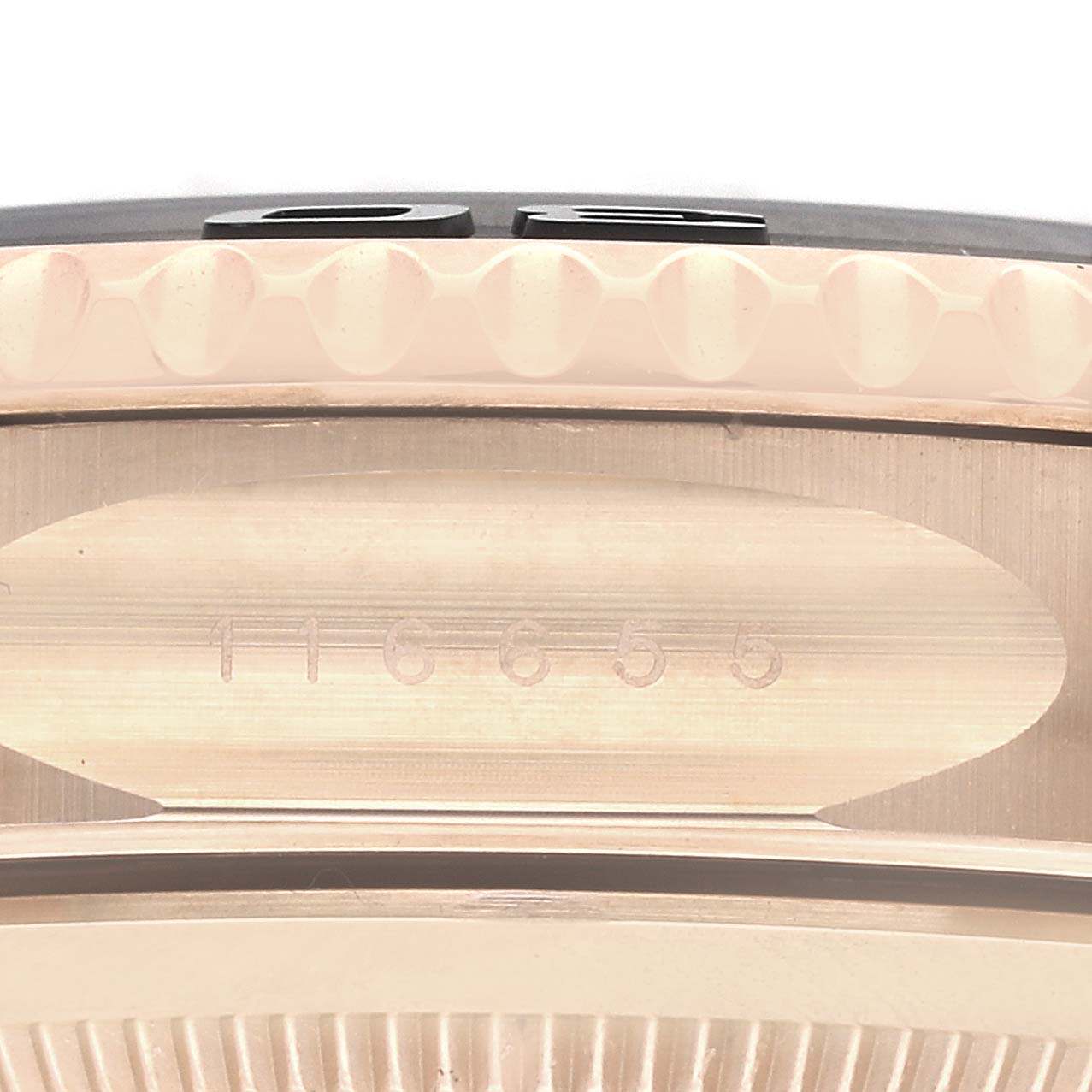 This image shows a close-up view of the side of a Rolex Yacht-Master 116655 Men's Rose Gold Black Dial 116655 Men's Rose Gold Black Dial watch, focusing on its case with an engraved serial number.
