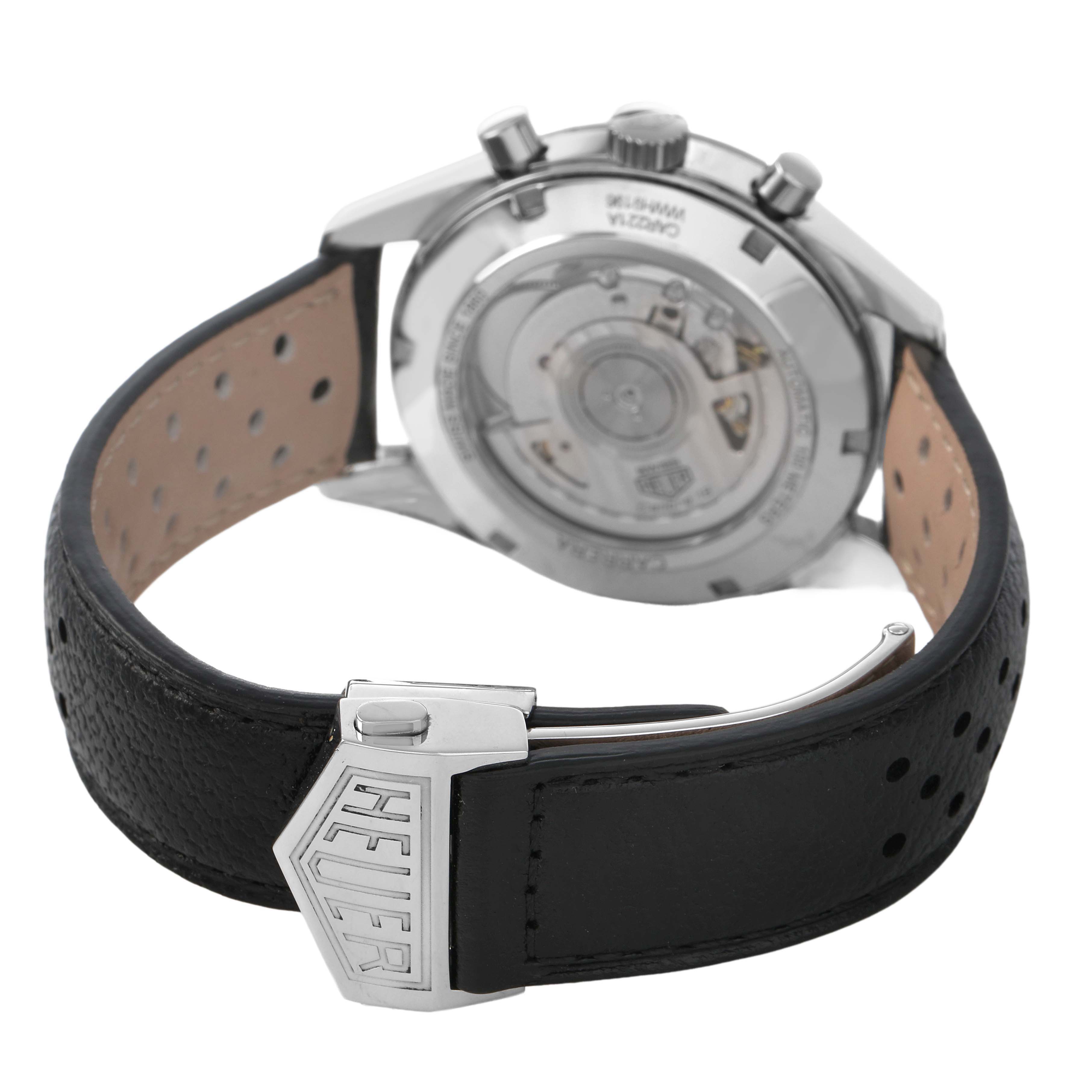 The Tag Heuer Carrera CAR221A Men's Stainless Steel Silver Dial watch is shown from the back, highlighting the case back and leather strap with a clasp.