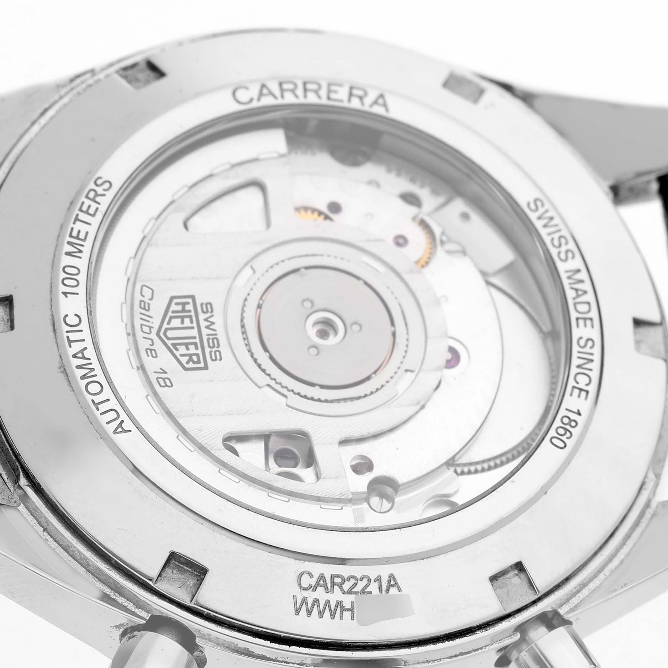 The image shows the back of a Tag Heuer Carrera CAR221A Men's Stainless Steel Silver Dial watch, displaying the movement and inscriptions like "Automatic 100 Meters."