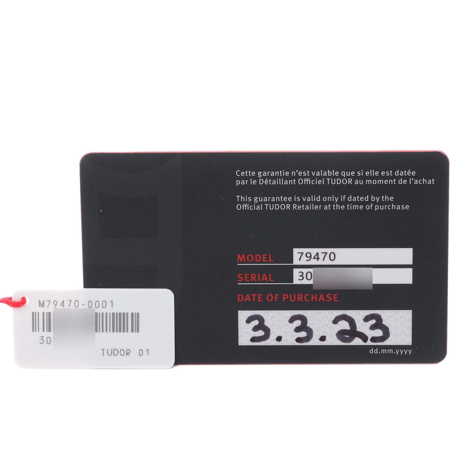 The image shows the warranty card and tag for the Tudor Heritage Black Bay M79470-001 Men
s Stainless Steel Black Dial M79470-001 Men
s Stainless Steel Black Dial model 79470 watch.