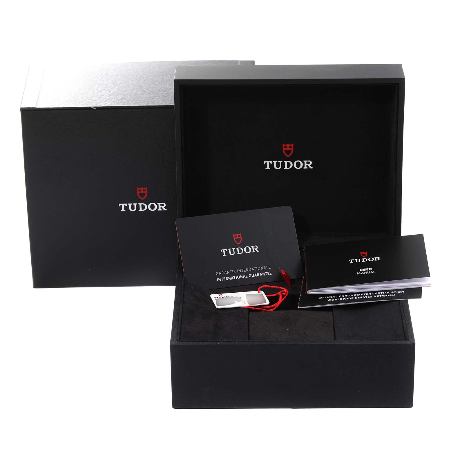 The image shows the packaging and accessories for the Tudor Heritage Black Bay M79470-001 Men
s Stainless Steel Black Dial M79470-001 Men
s Stainless Steel Black Dial watch, including a box, guarantee card, and user manual.