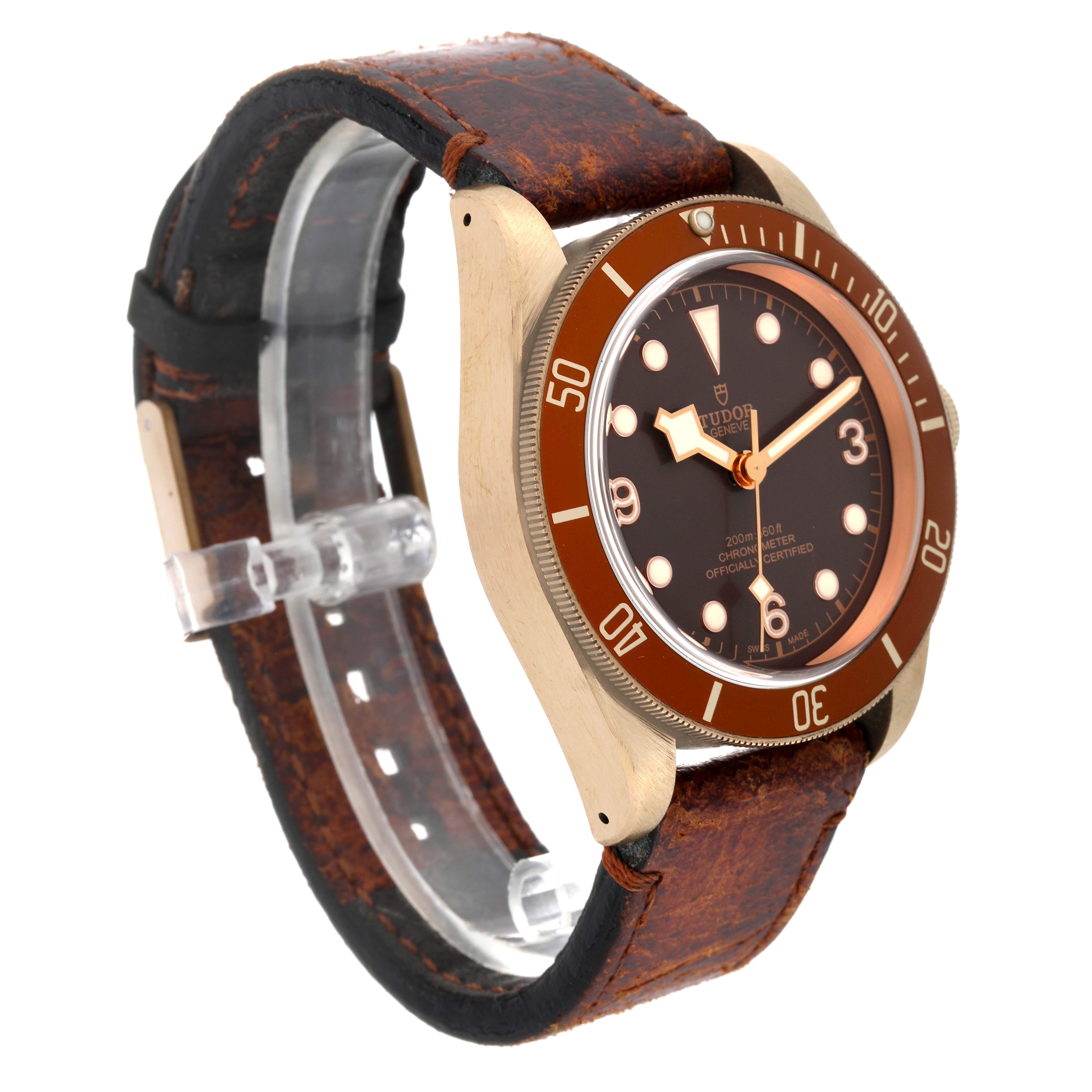 The image shows a side and front angle view of a Tudor Heritage Black Bay 79250B Men's Bronze Brown Dial 79250B Men's Bronze Brown Dial watch with a brown bezel and a distressed leather strap.