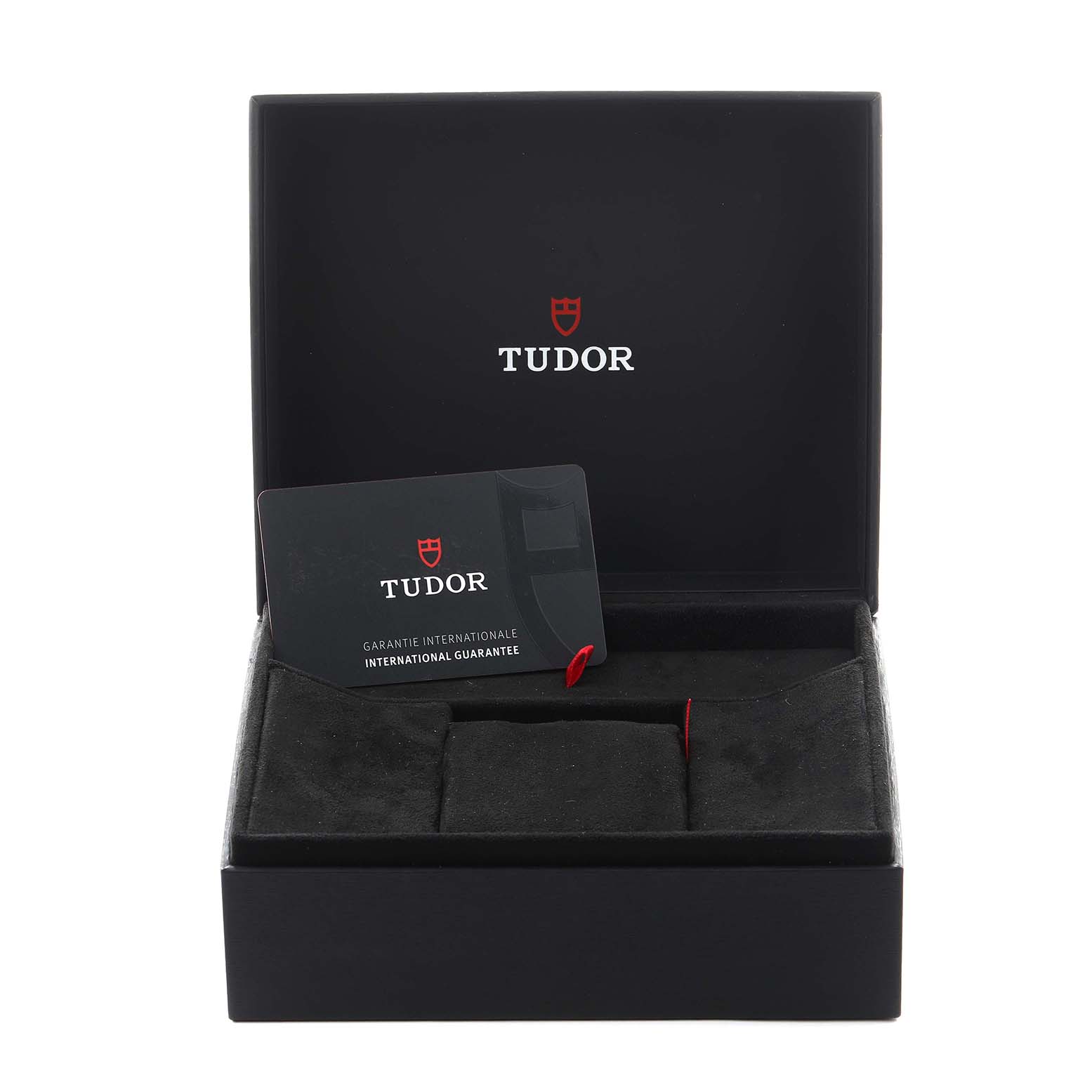 The image shows an open box for a Tudor Heritage Black Bay 79350 Men
s Stainless Steel Black Dial 79350 Men
s Stainless Steel Black Dial watch, featuring the guarantee card inside.