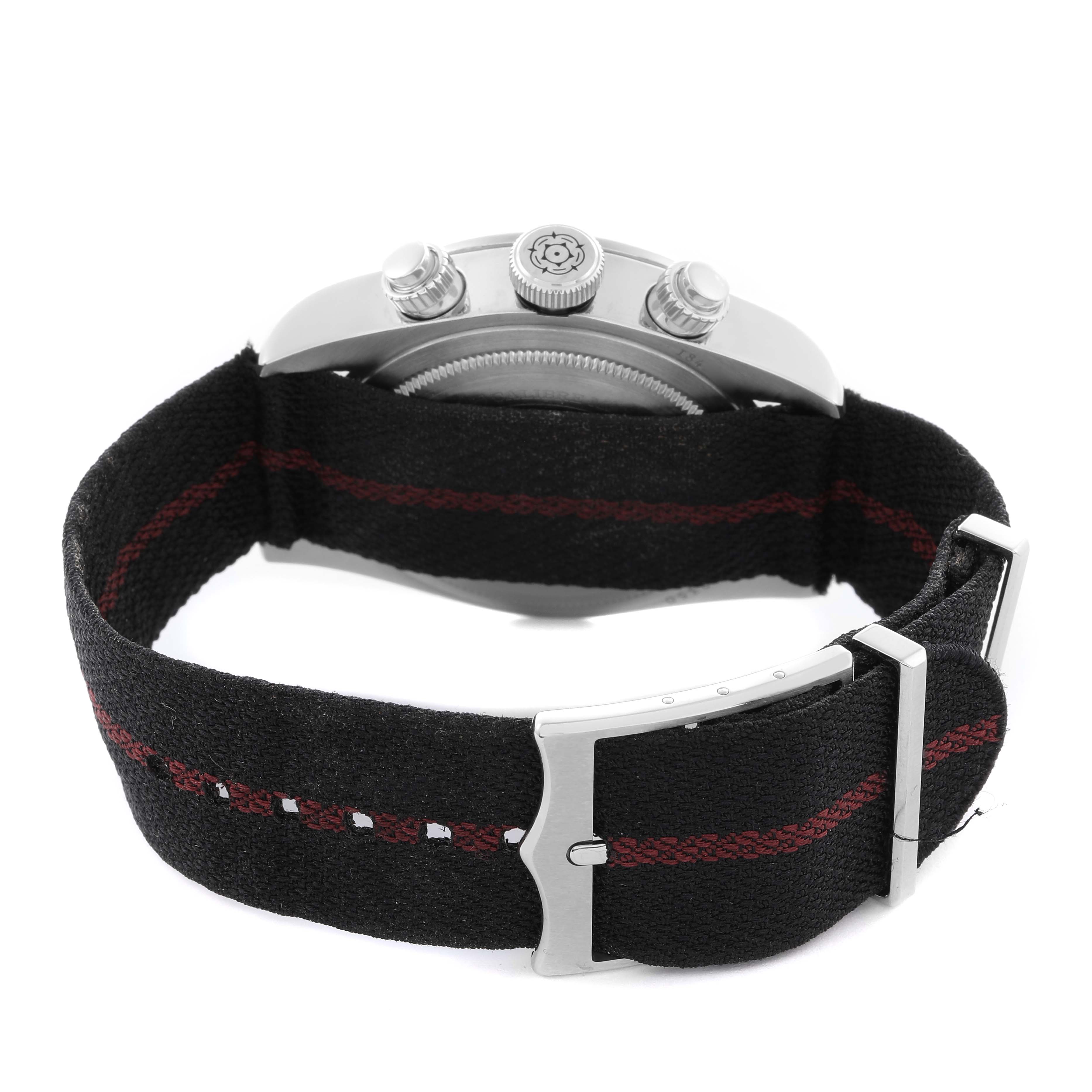 The image shows a Tudor Heritage Black Bay 79350 Men
s Stainless Steel Black Dial 79350 Men
s Stainless Steel Black Dial watch from the rear angle, highlighting the fabric strap and clasp.