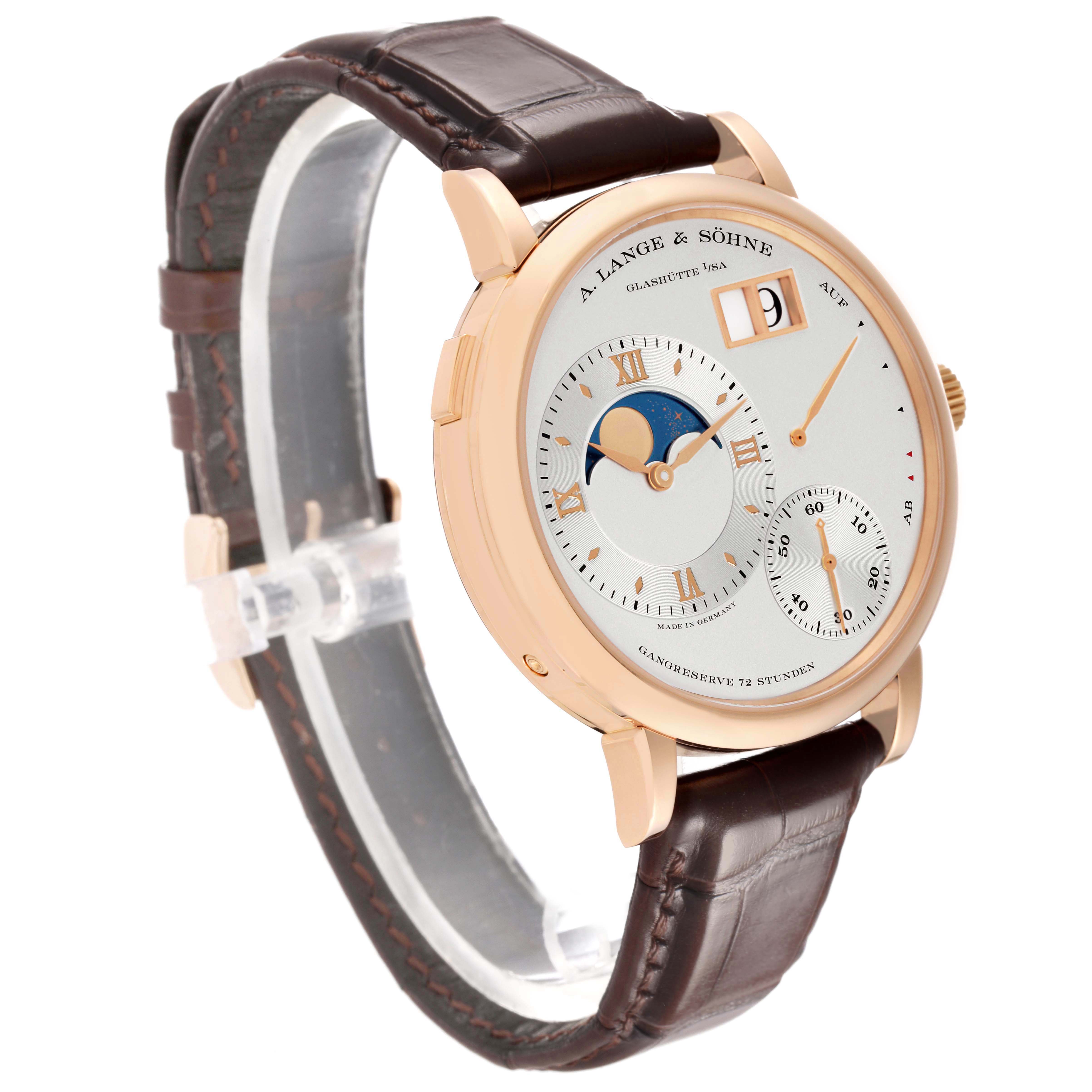 The Lange 1 by A. Lange & Söhne is shown at a three-quarter angle, highlighting the dial, lugs, and leather strap.