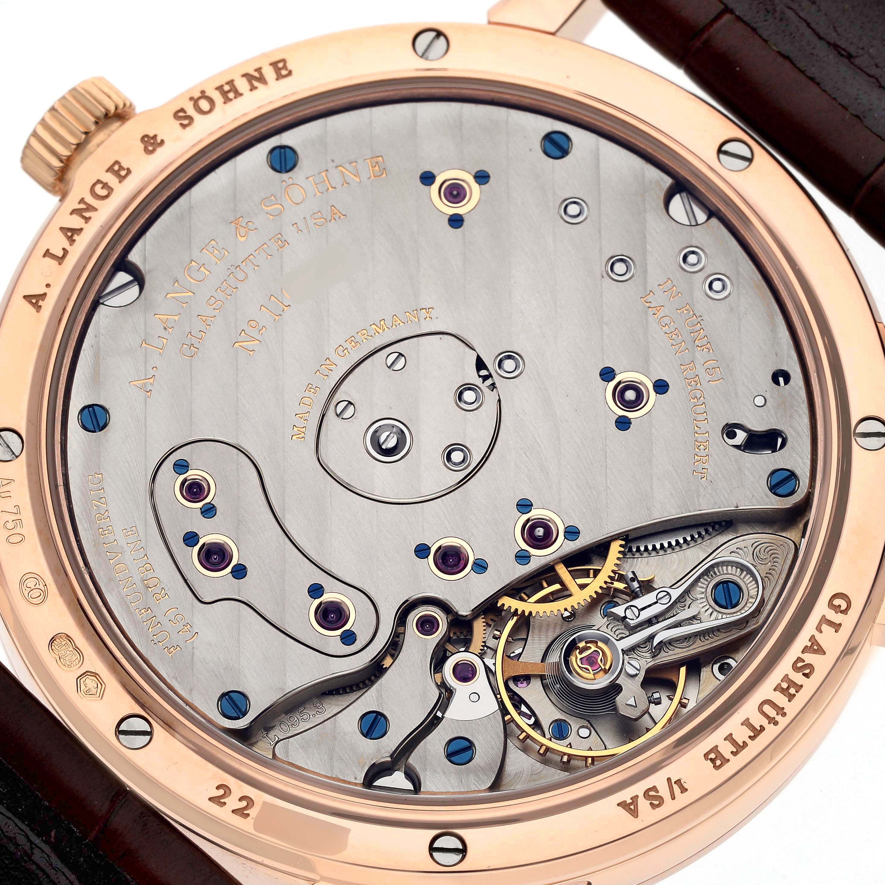 The image shows the back view of an A. Lange & Sohne Lange 1 139.032 Men's Rose Gold Silver Dial watch, highlighting its intricate movement and components.