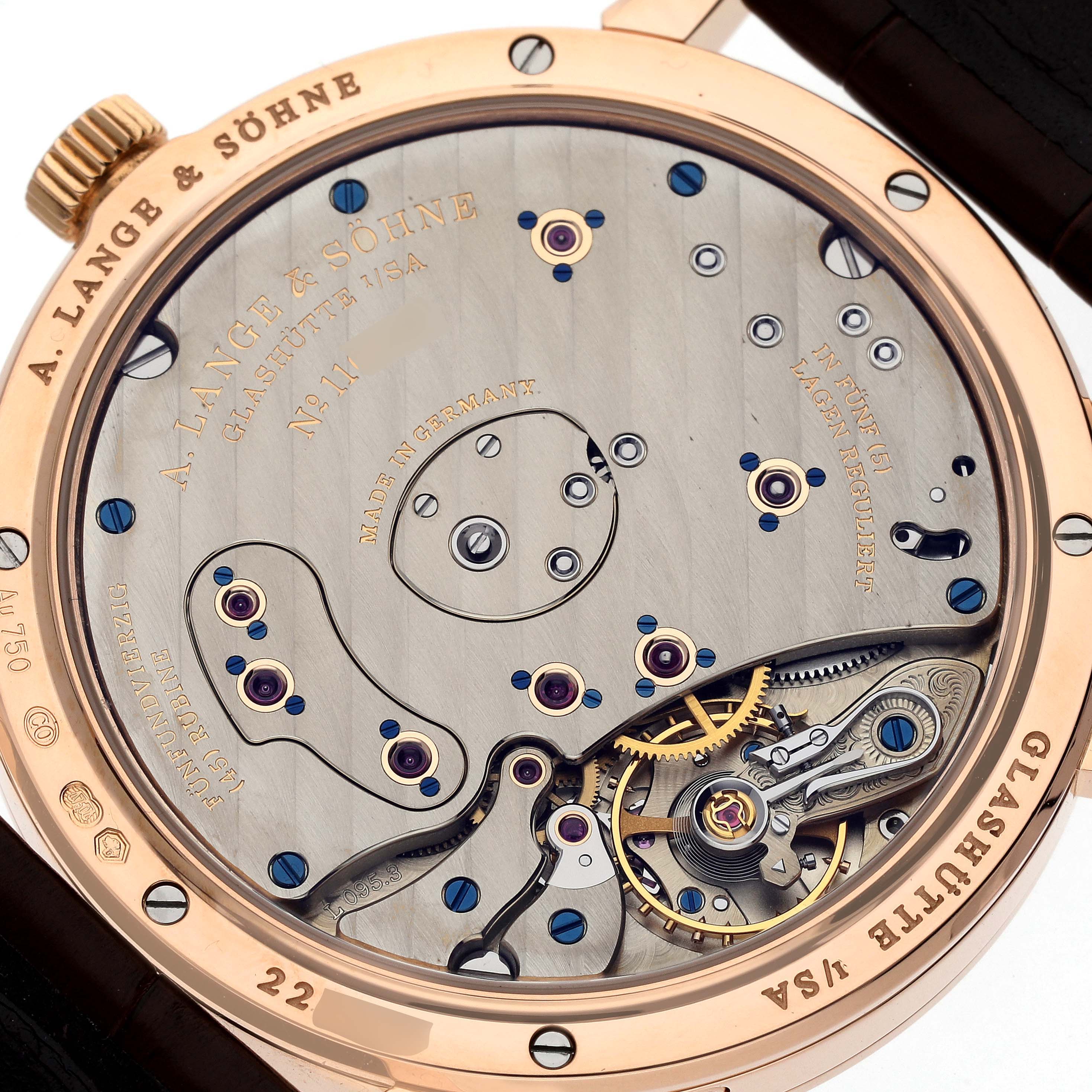 The image shows the back view of the A. Lange & Sohne Lange 1 139.032 Men's Rose Gold Silver Dial watch, highlighting its intricate mechanical movement.