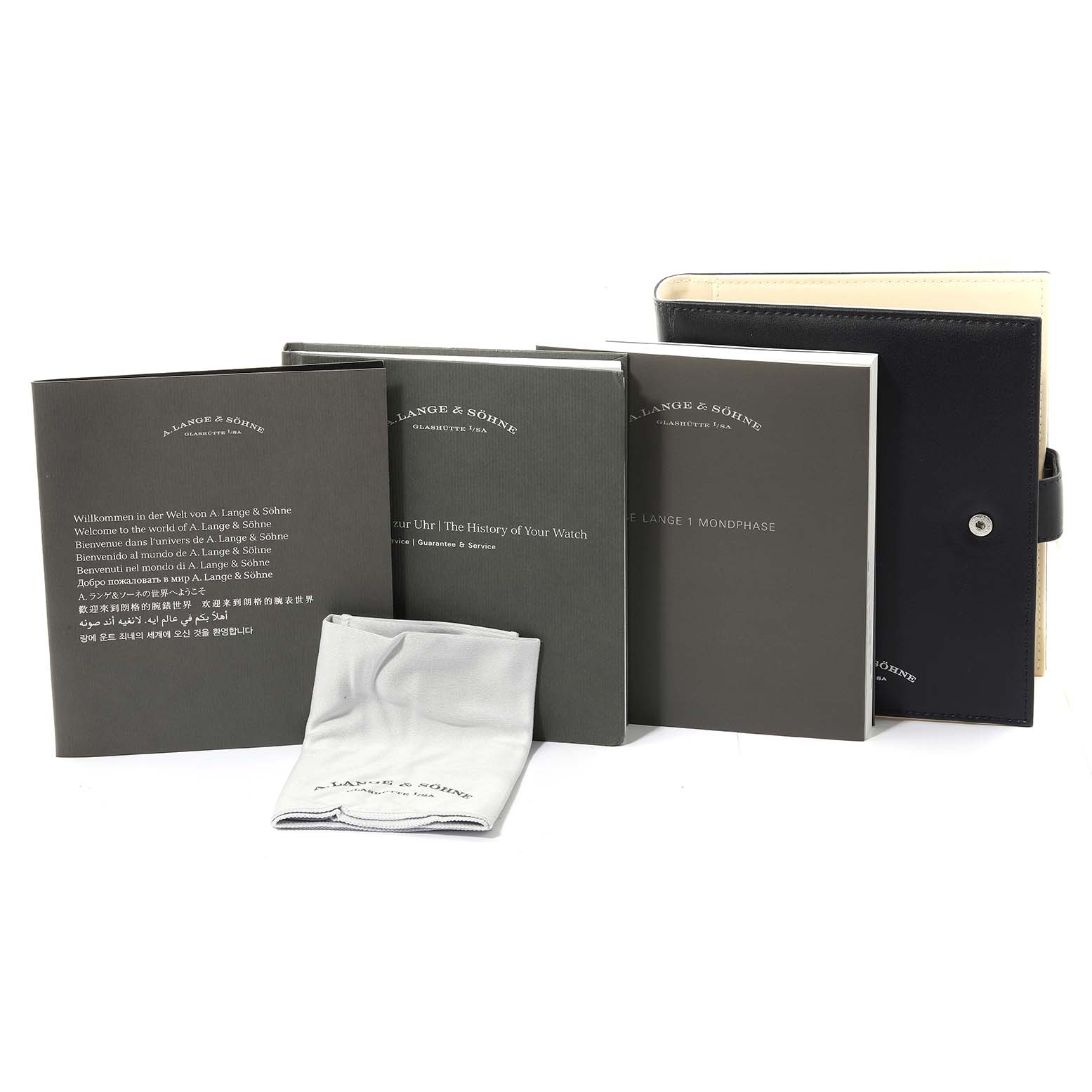 The image shows A. Lange & Sohne Lange 1 139.032 Men's Rose Gold Silver Dial watch accessories, including manuals, a cloth, and a black case, laid out at the front angle.