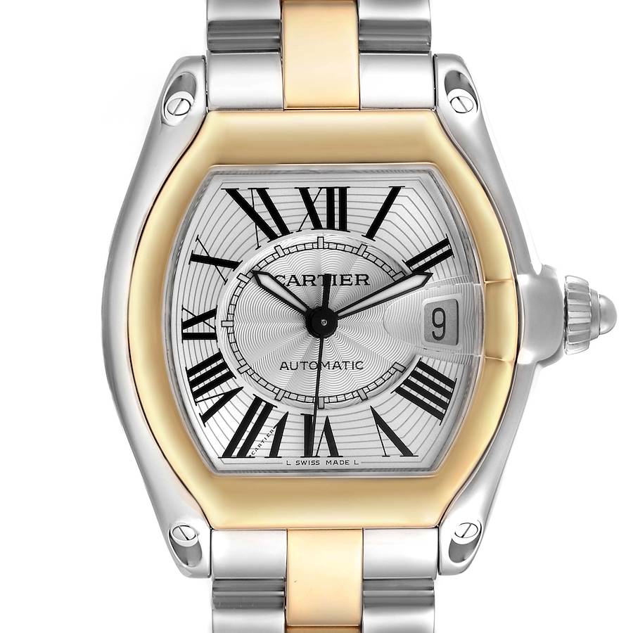The Cartier Roadster watch is shown from a frontal angle, highlighting its face, Roman numerals, date window, and metal bracelet.