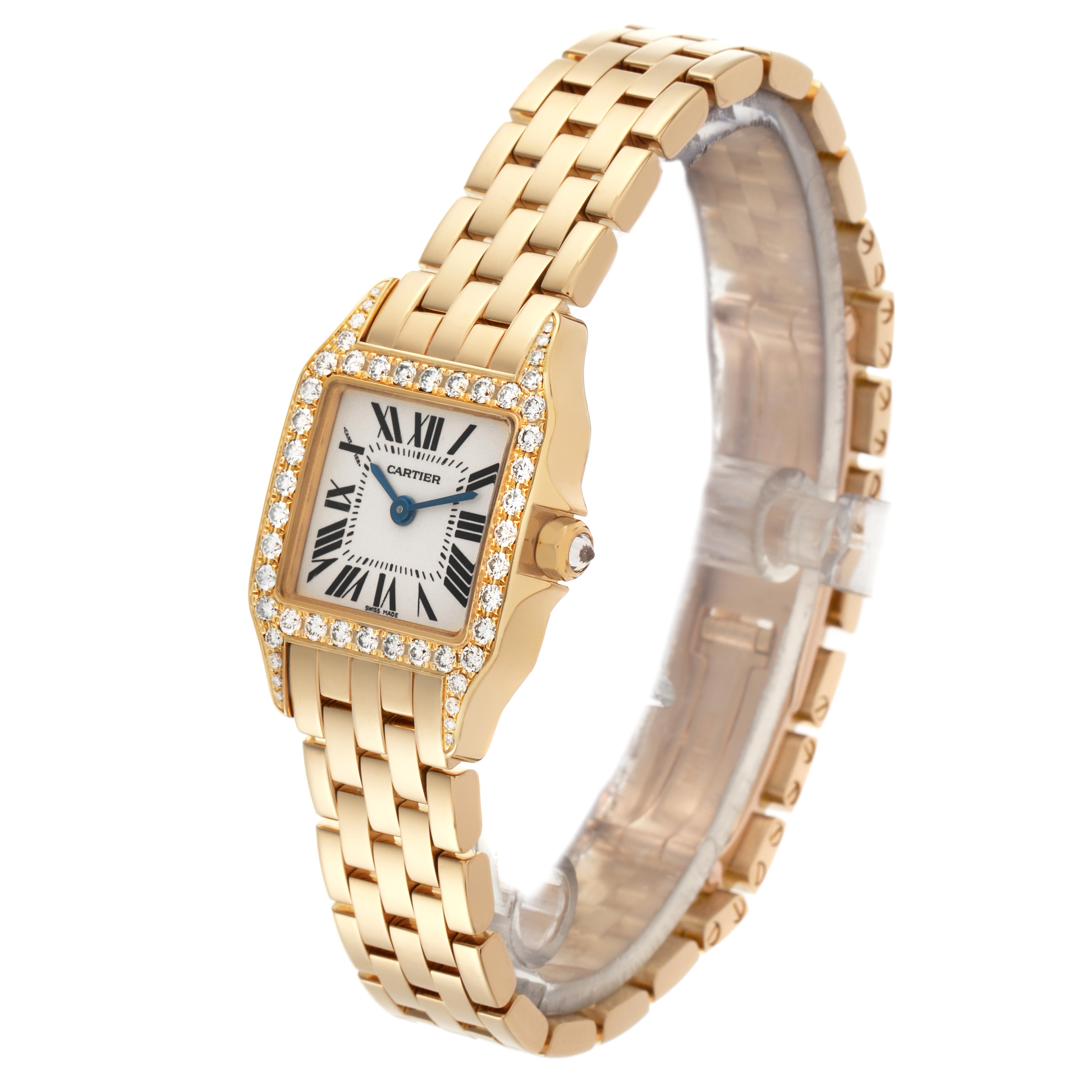 The Cartier Santos Demoiselle WF9001Y7 Women
s Yellow Gold Silver Dial WF9001Y7 Women
s Yellow Gold Silver Dial watch is shown at a slight angle, highlighting its gold bracelet and diamond-bezel square face.
